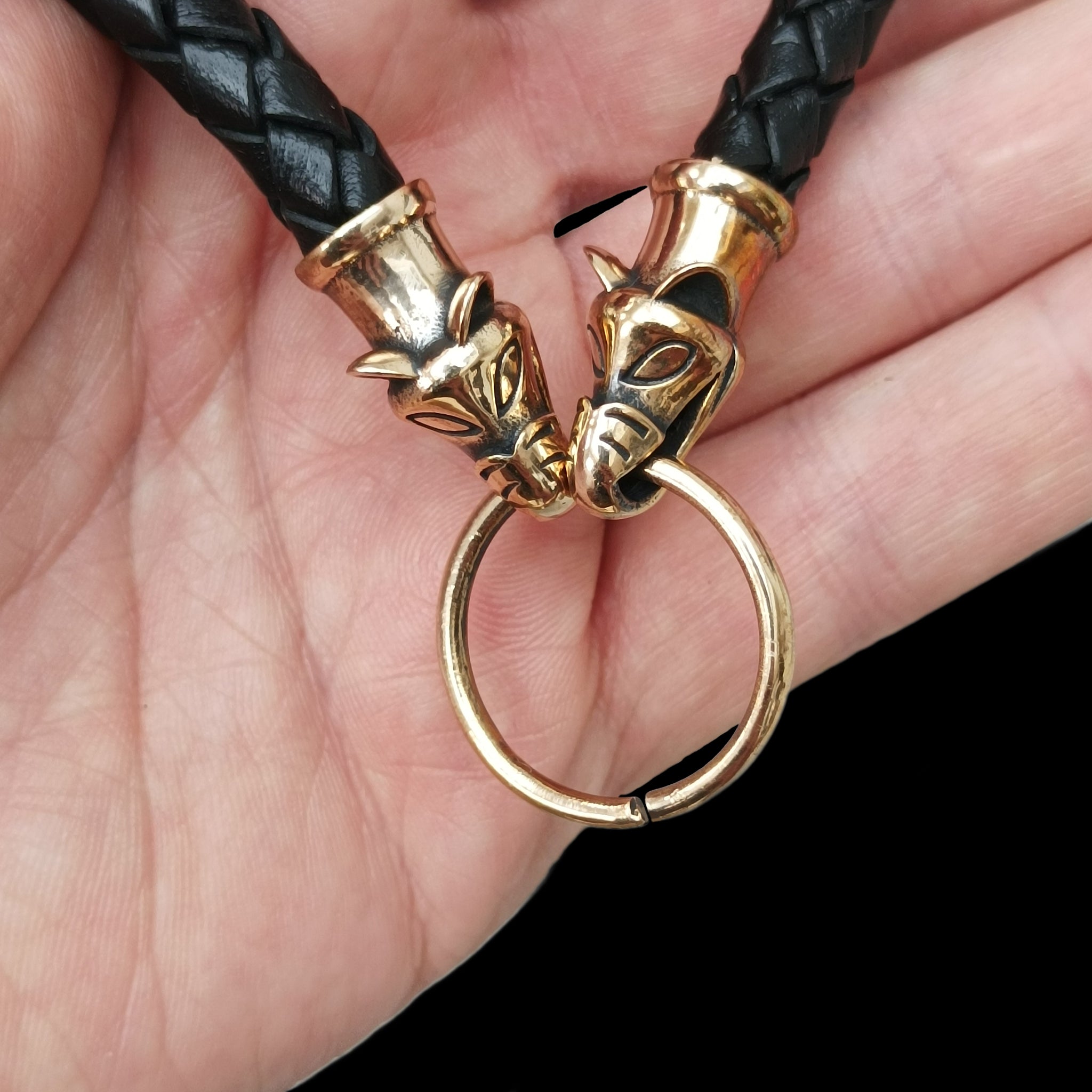 8mm Width Braided Leather Necklace with Bronze Icelandic Wolf Heads and Split Ring in Hand