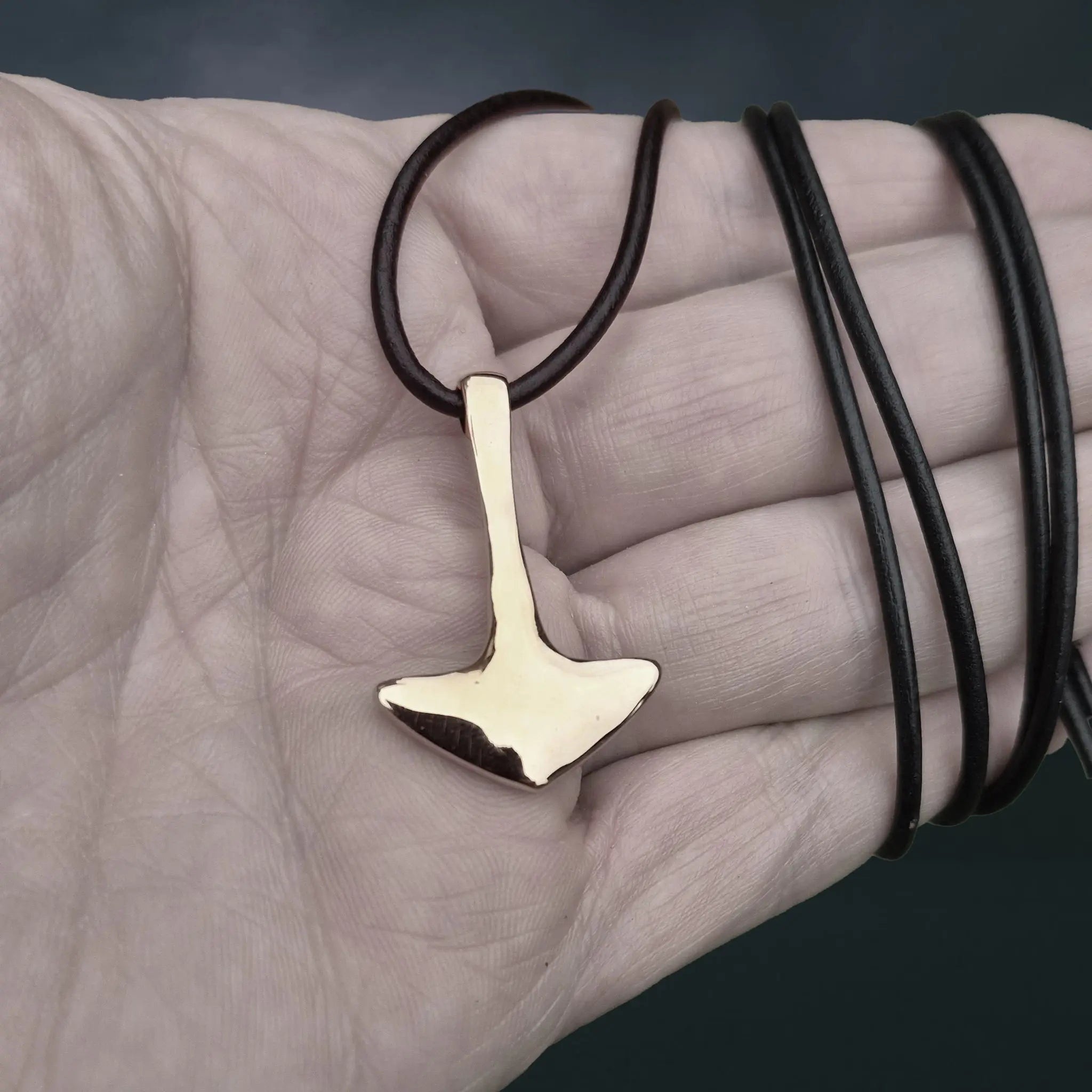 Bronze Replica Thor's Hammer Pendant from Repton, England, UK on Leather Cord on Hand