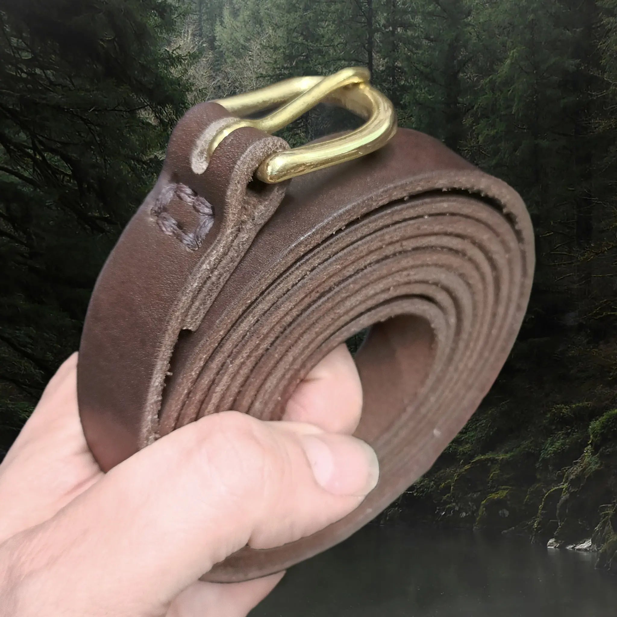 Long Leather Brown Baldric with Brass Buckle in Hand - Coiled Up Angle View