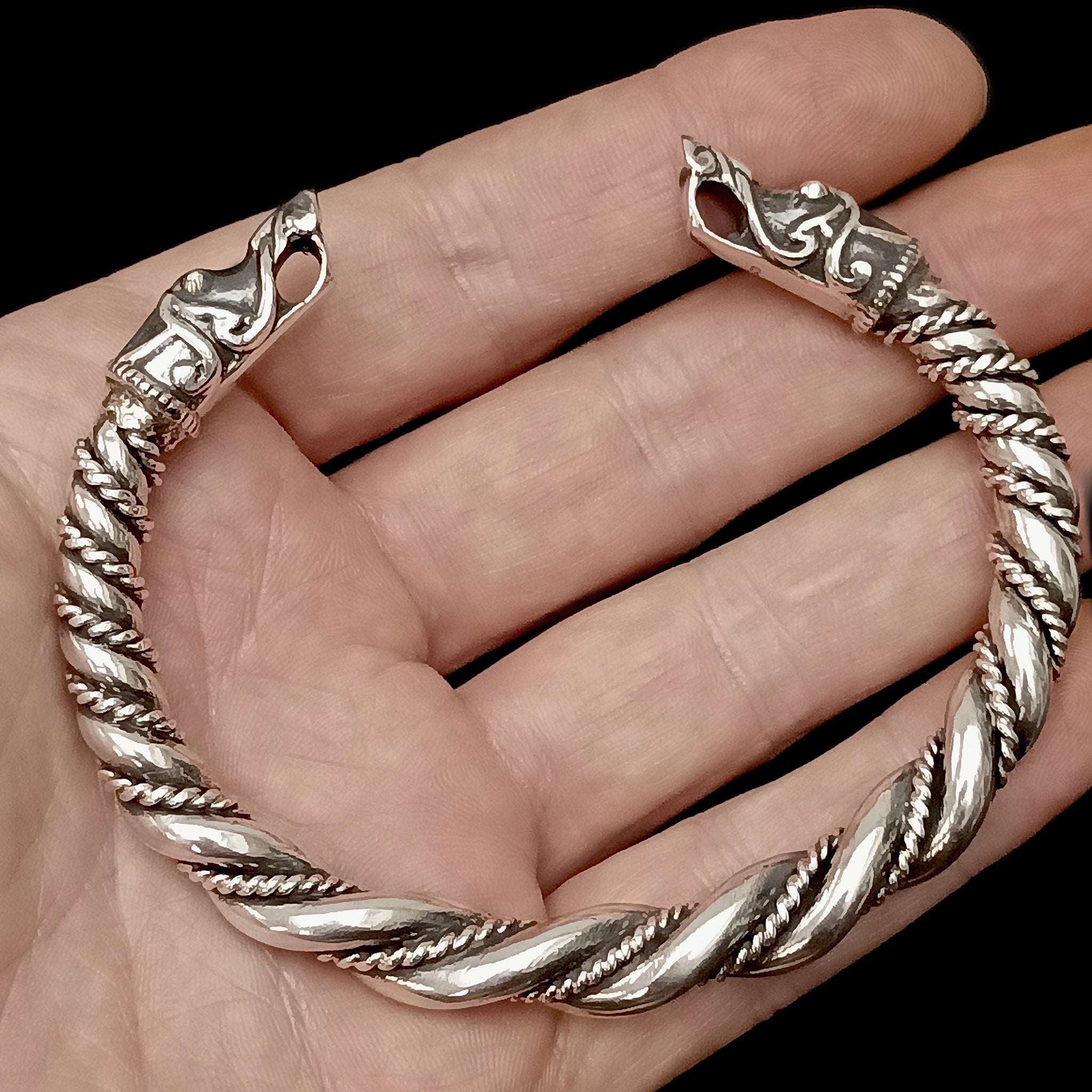 Thick Twisted Silver Arm Ring With Gotlandic Dragon Heads on Hand