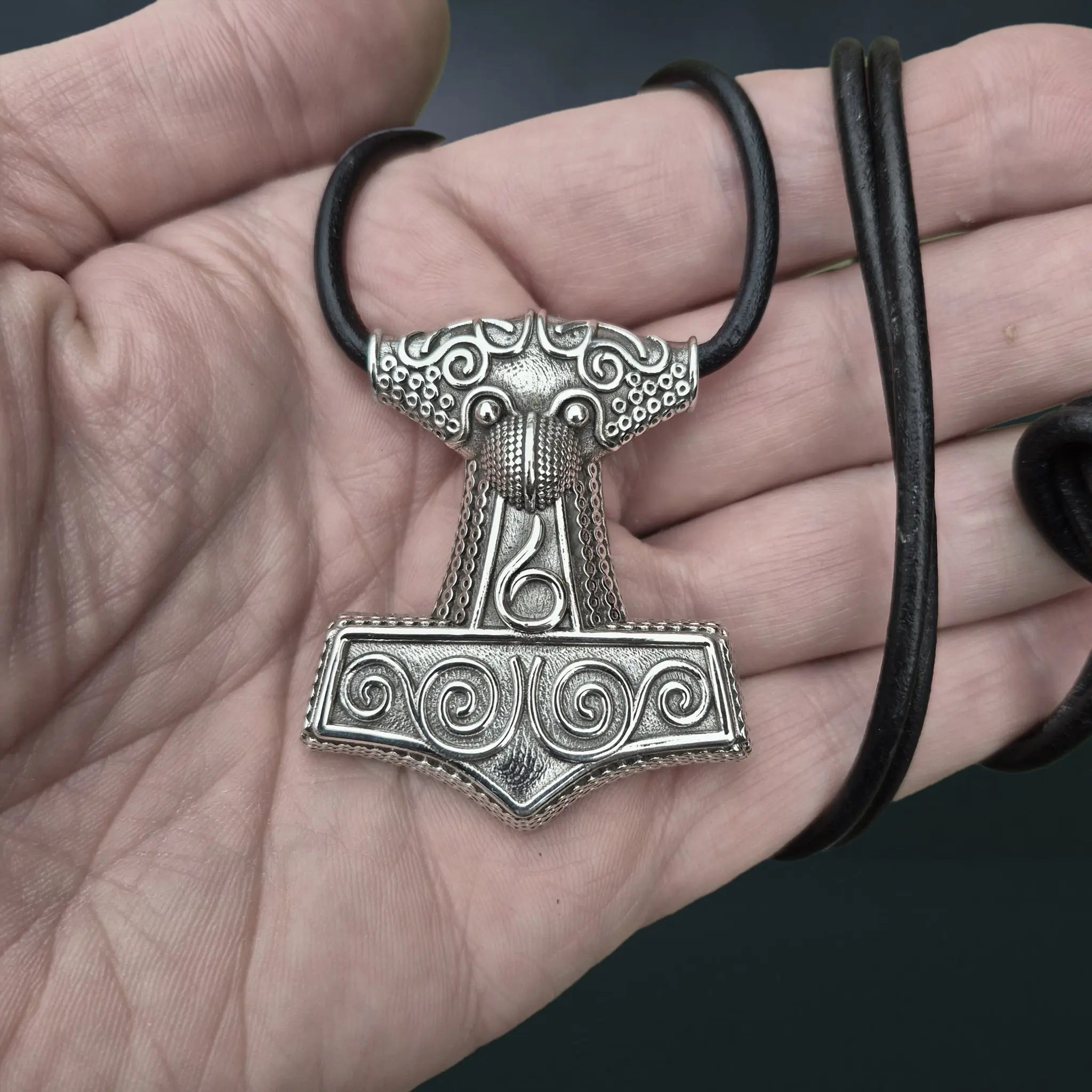 Large Silver Skåne Thor's Hammer Pendant Replica on 3mm Black Leather Cord Wrapped around Hand