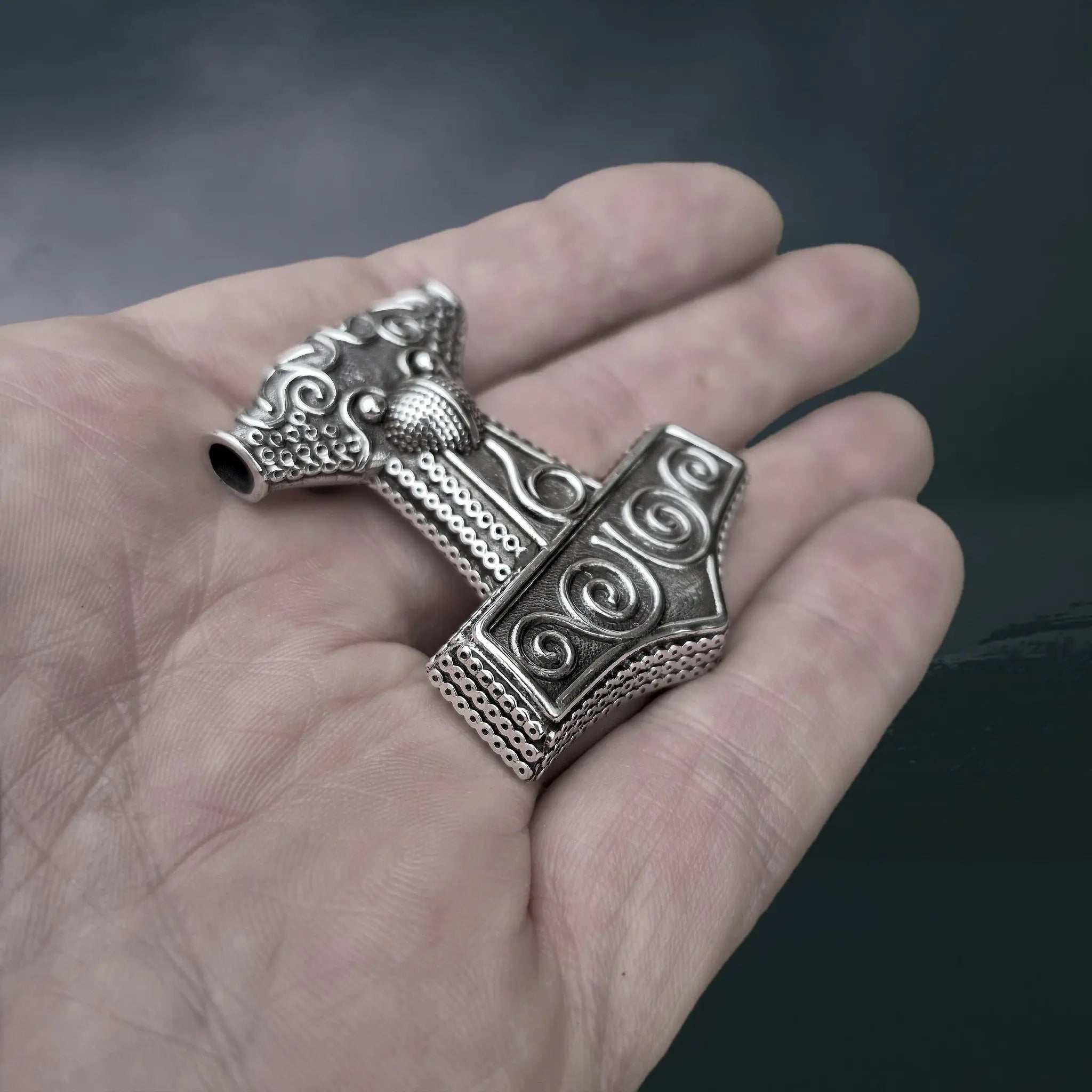 Large Silver Skåne Thor's Hammer Pendant Replica on Hand - Side Angle View