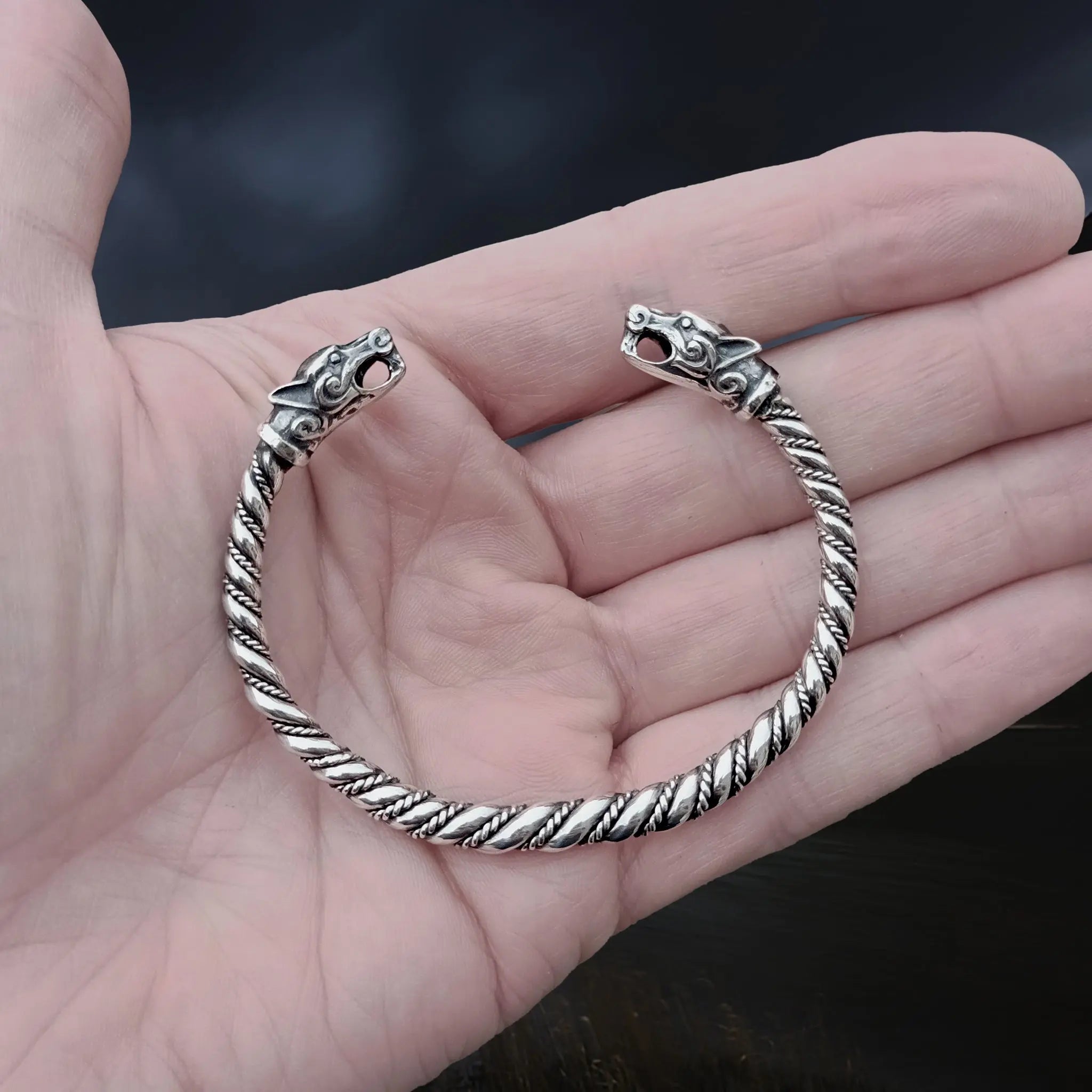 Twisted Silver Viking Bracelet With Ferocious Wolf Heads on Hand
