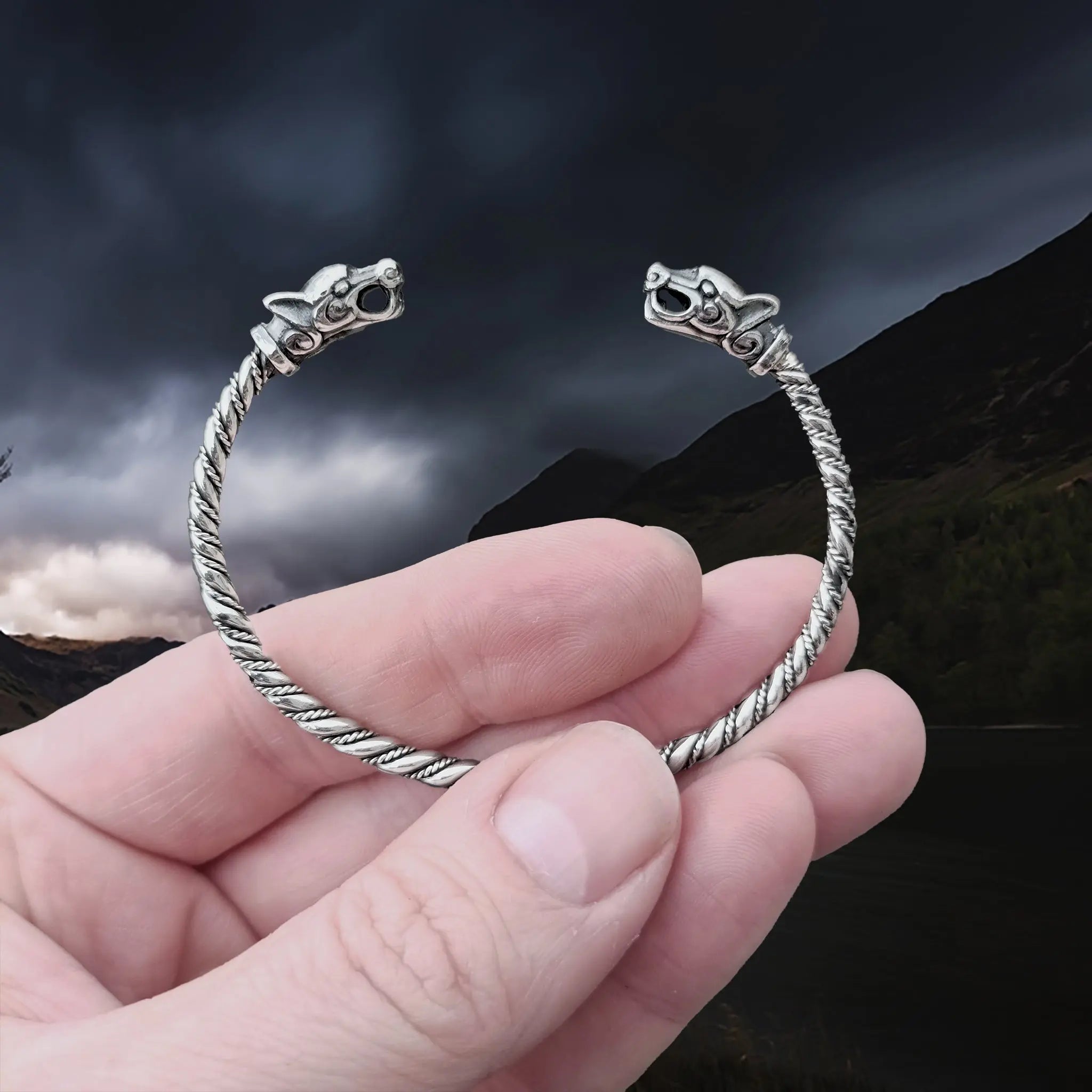 Slim Twisted Silver Viking Bracelet With Ferocious Wolf Heads in Hand