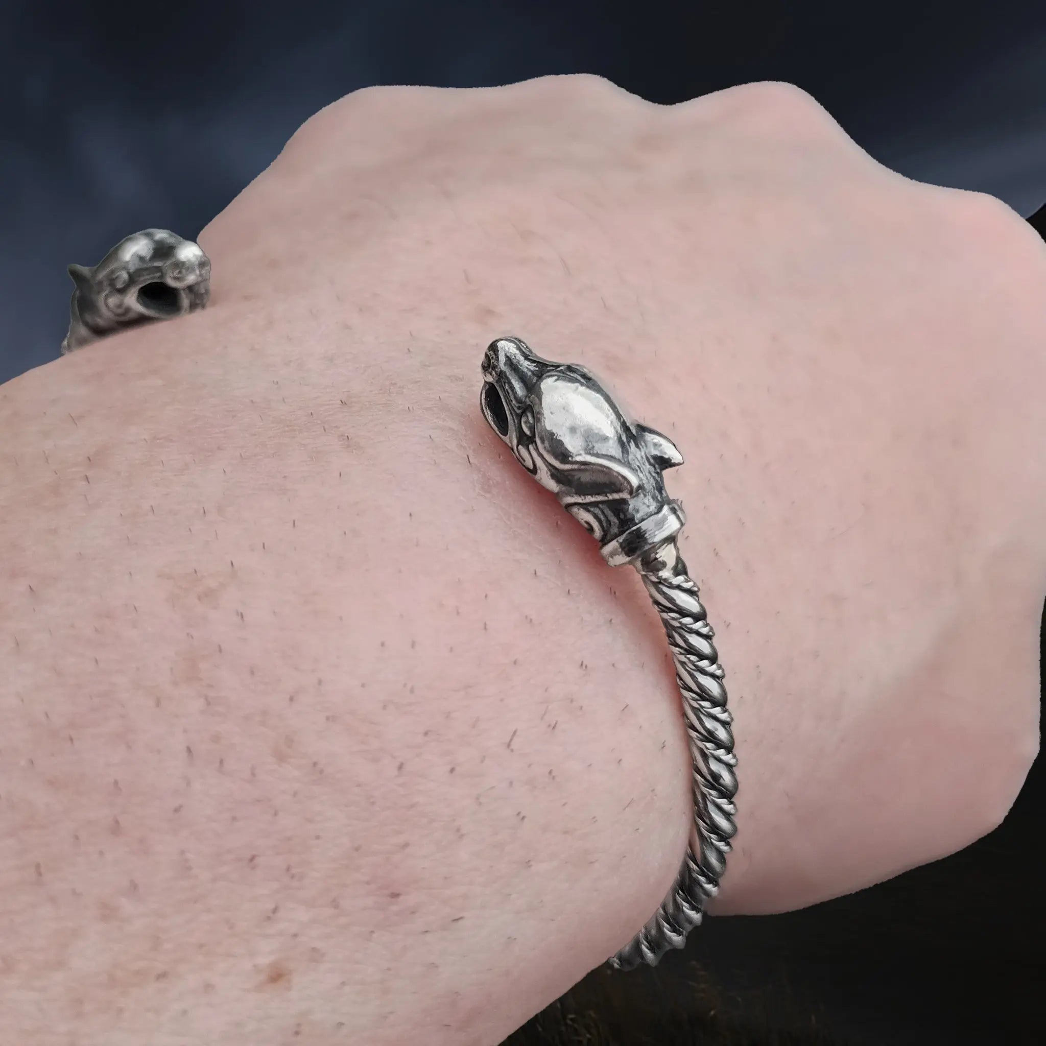 Slim Twisted Silver Viking Bracelet With Ferocious Wolf Heads on Wrist - Closer Angle View