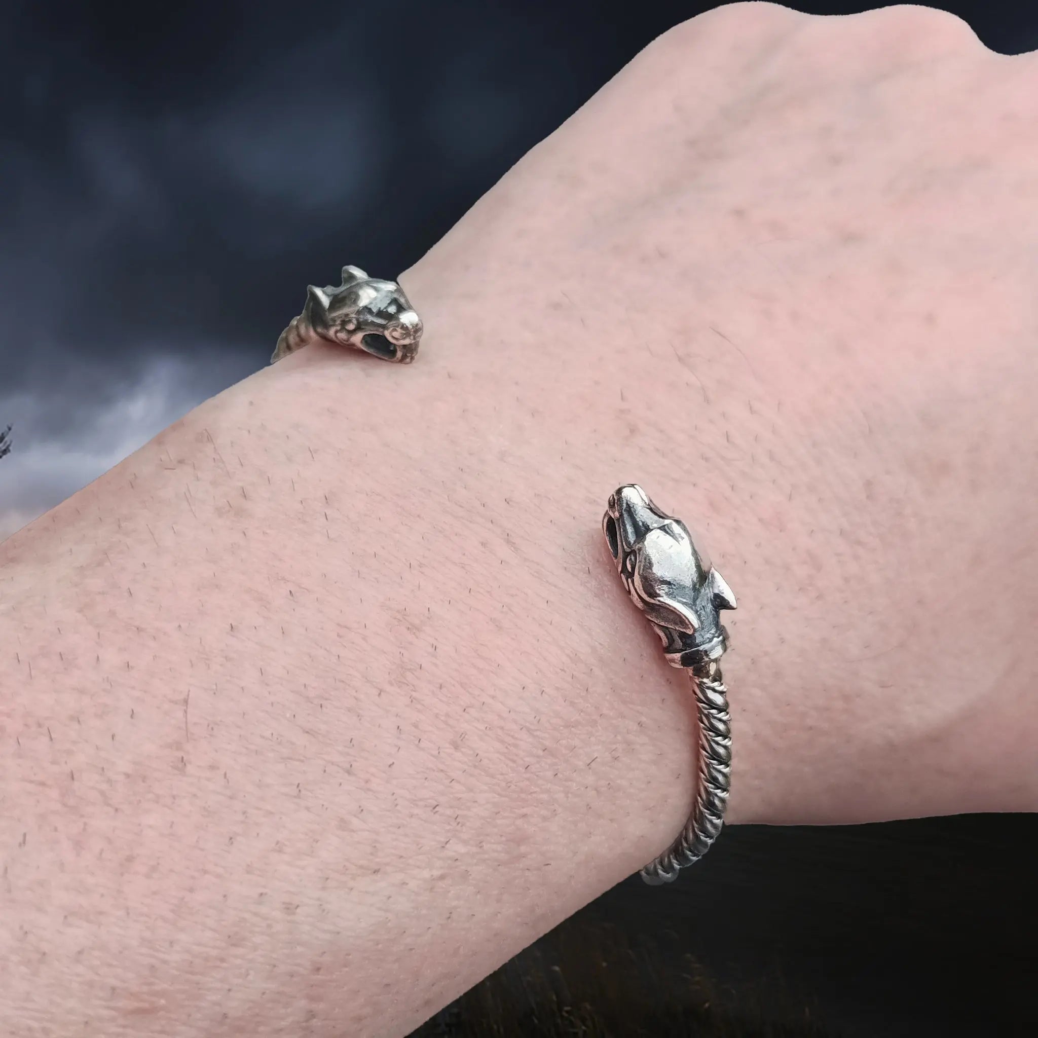 Slim Twisted Silver Viking Bracelet With Ferocious Wolf Heads on Wrist