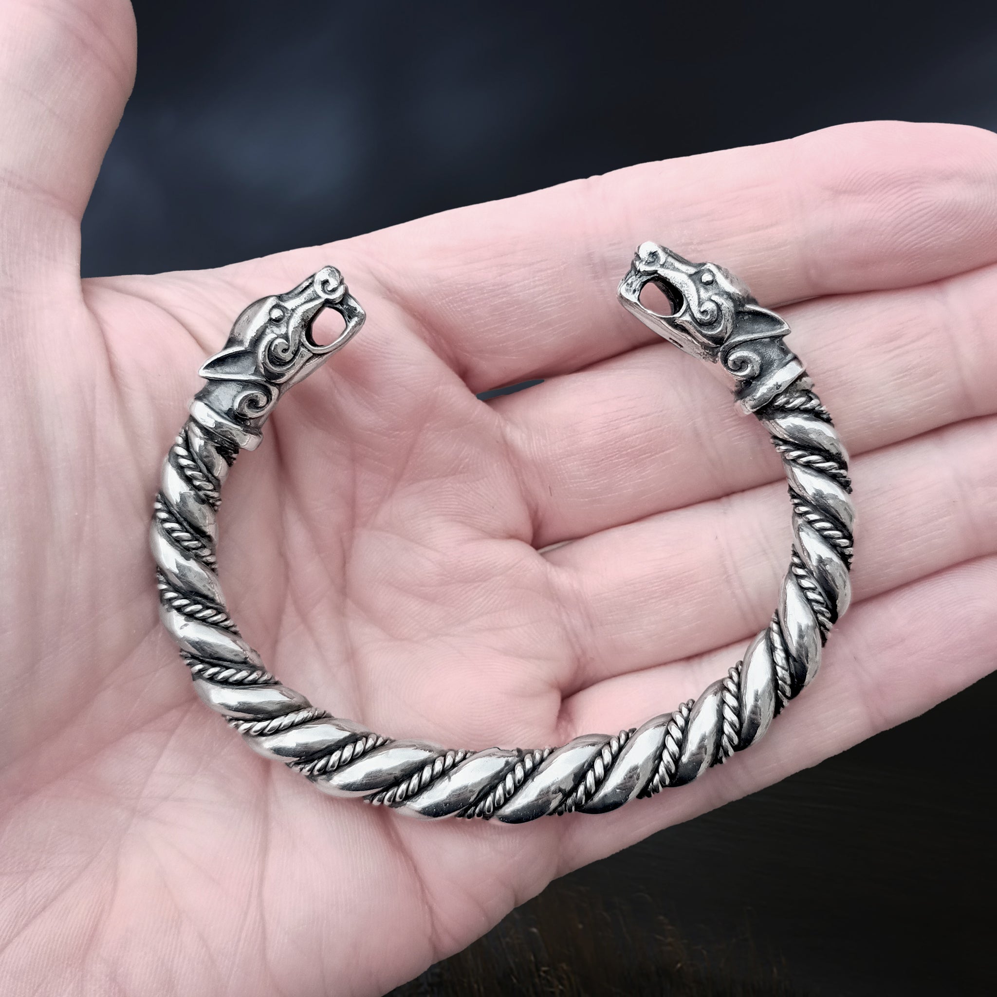 Thick Twisted Silver Viking Bracelet / Arm Ring With Ferocious Wolf Heads on Hand