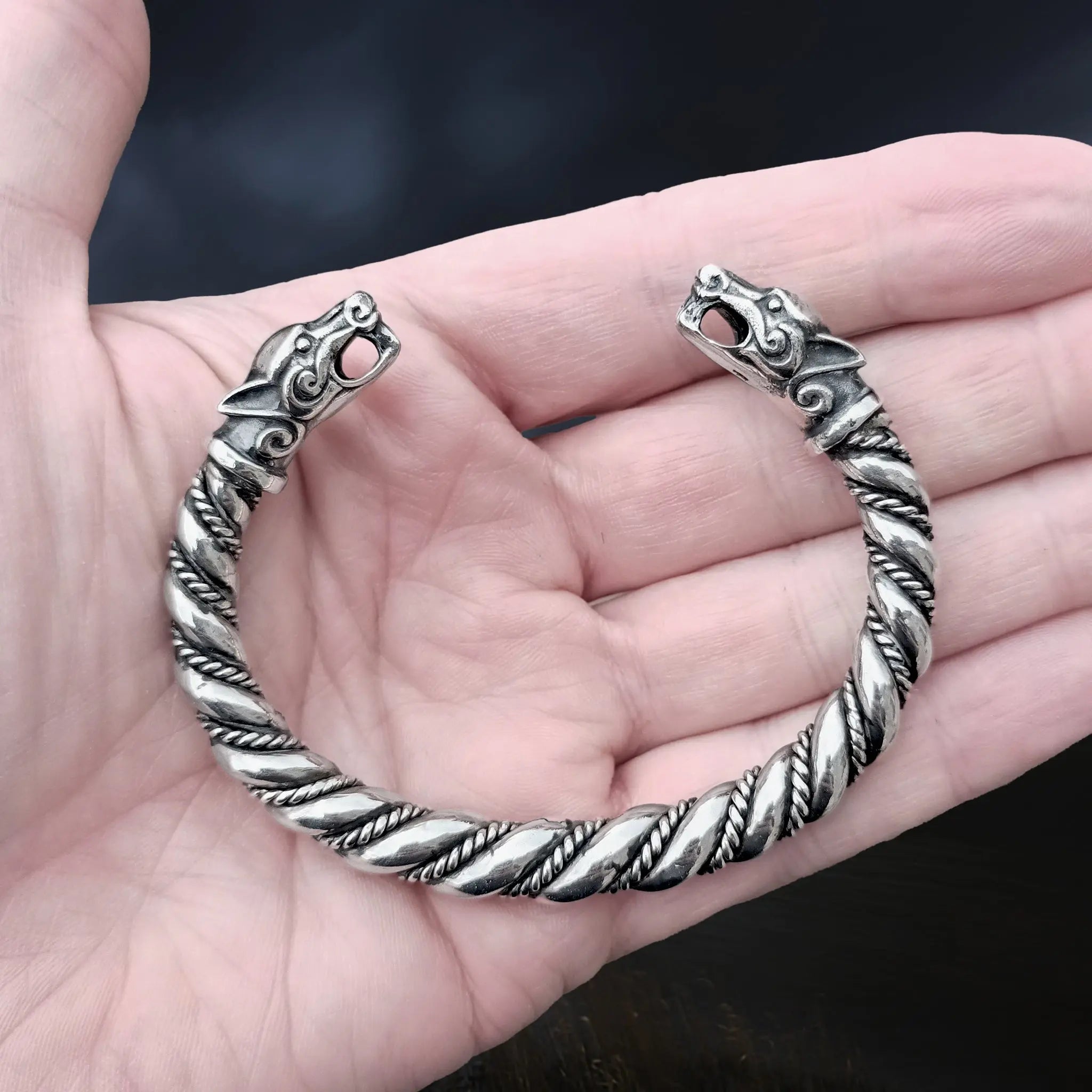 Thick Twisted Silver Viking Bracelet / Arm Ring With Ferocious Wolf Heads on Hand