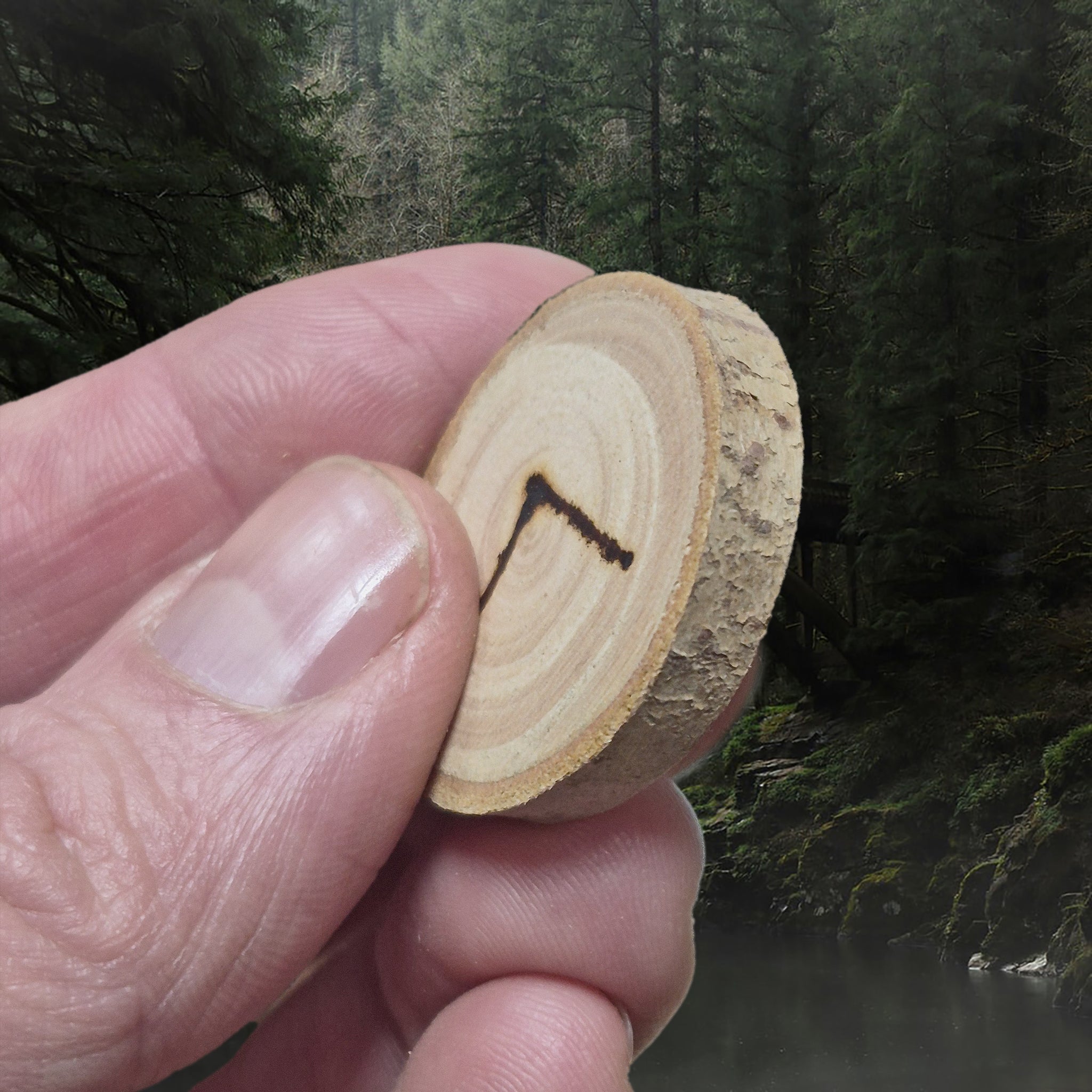 Kenaz Elder Futhark Wooden Rune in Fingers - Side Angle View