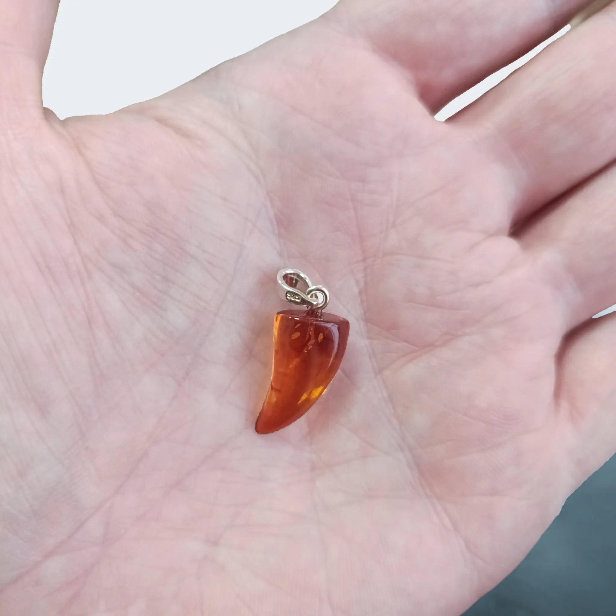 Hand-Cut & Polished Amber Pendant, Shaped into a Wolf's / Dragon's Tooth with Sterling Silver Hanger on Hand