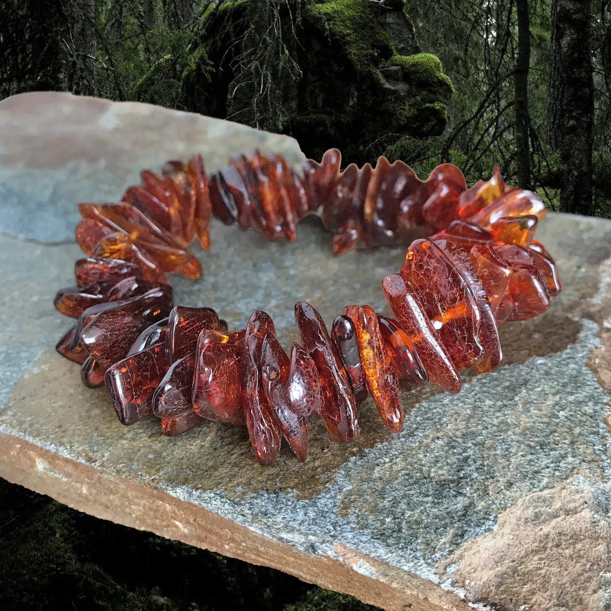 Amber Viking Bracelet Made From Cut and Polished Large Amber Chips on Rock - Front Angle View