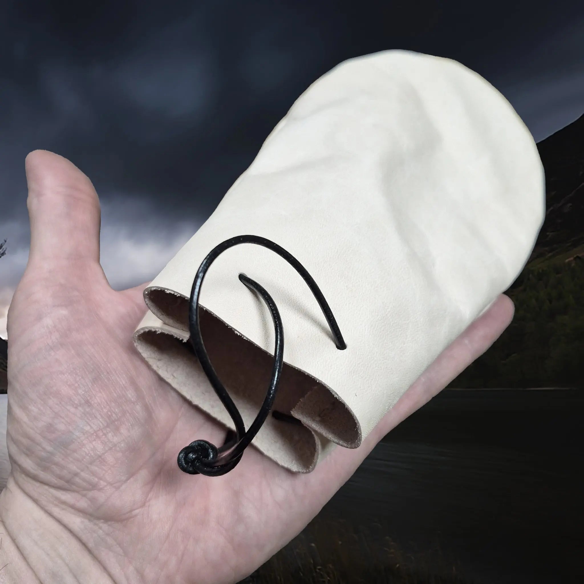 Medium Sized Natural Veg-Tan Leather Viking Pouch with Leather Drawstring on Hand - Angle View