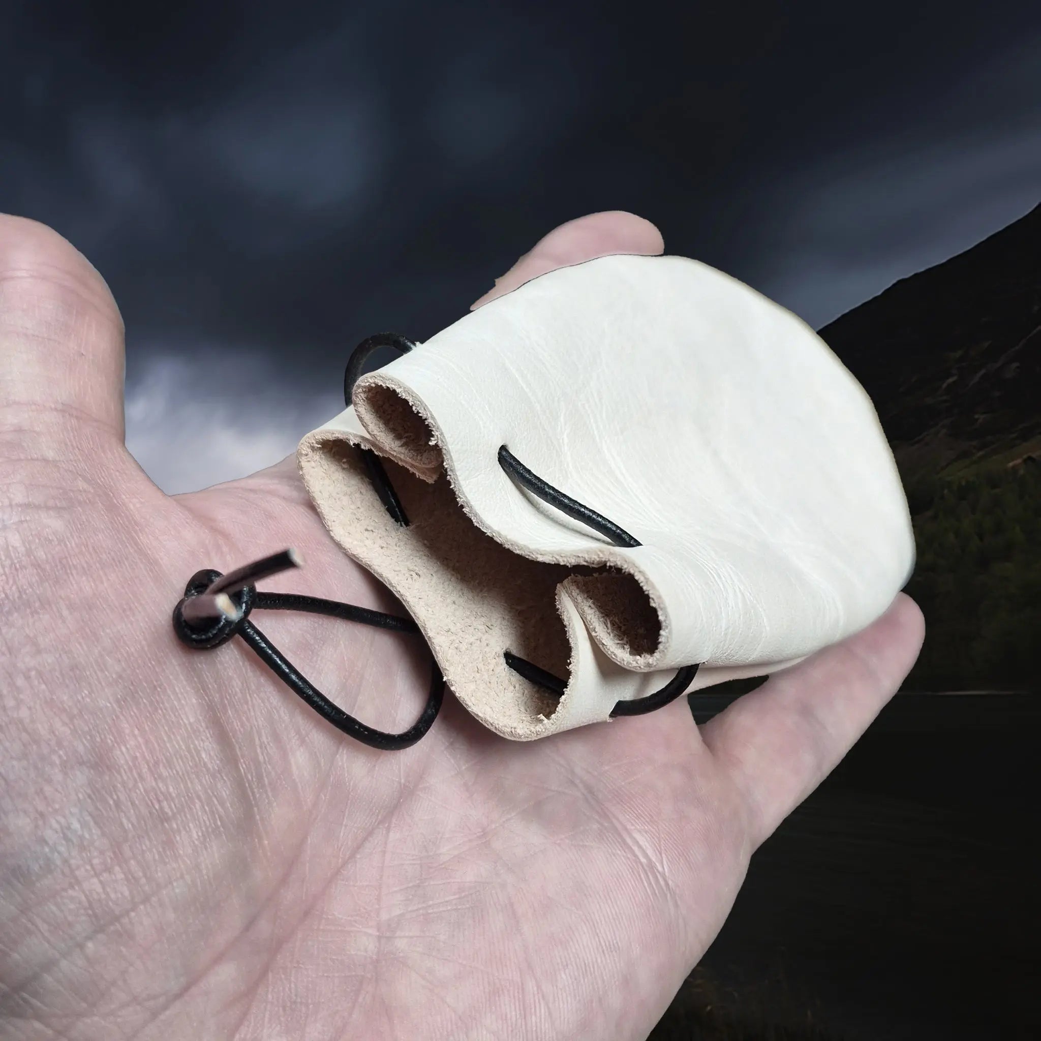 Natural Veg-Tan Leather Viking Pouch with Leather Drawstring Tie on Hand - Angle View