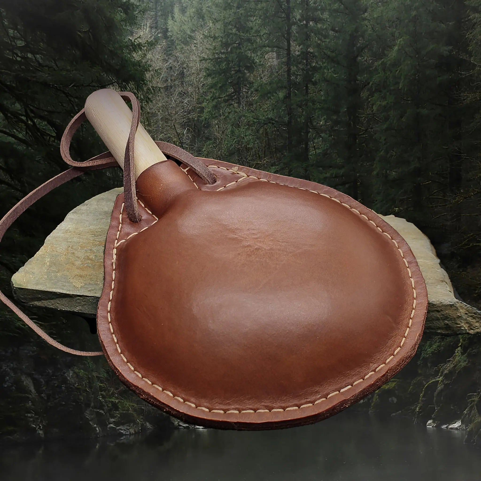 Handmade Thick Leather Water Bottle with Wood Stopper & Leather Carry Strap on Rock