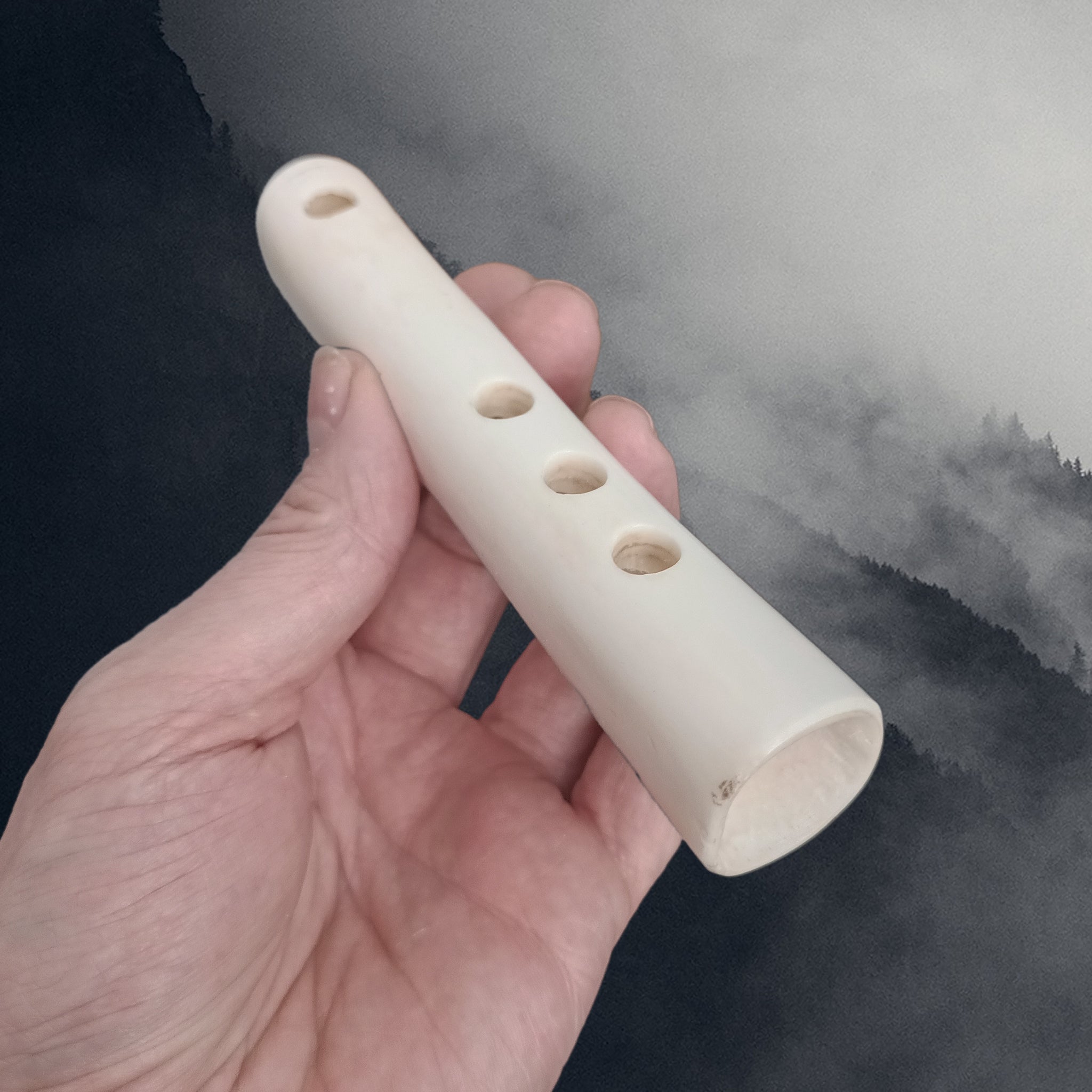 Replica Viking Age Bone Flute in Hand - Angle View
