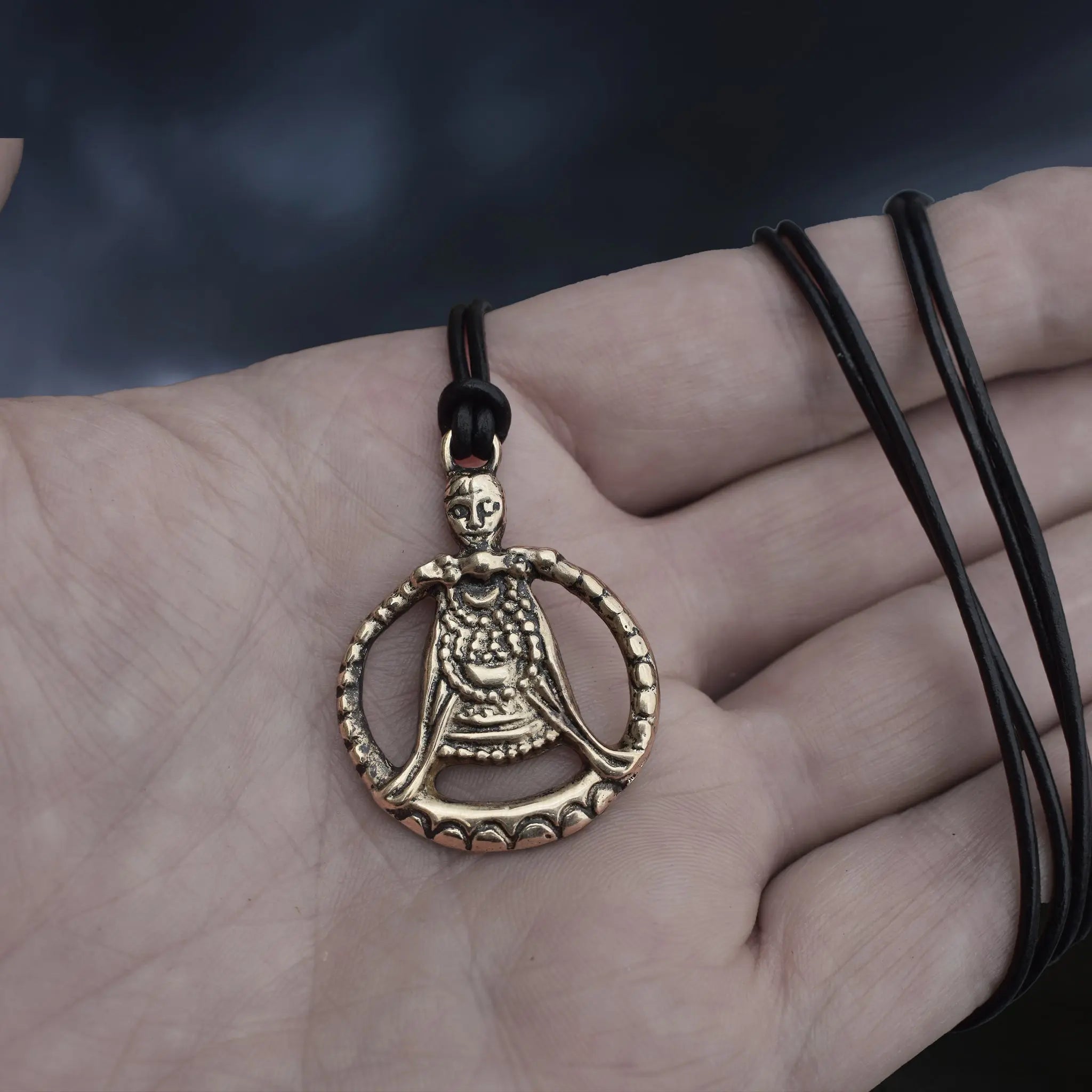 Large Bronze Circular Freya Pendant Replica with Top Loop on Leather Cord, Wrapped Around Hand