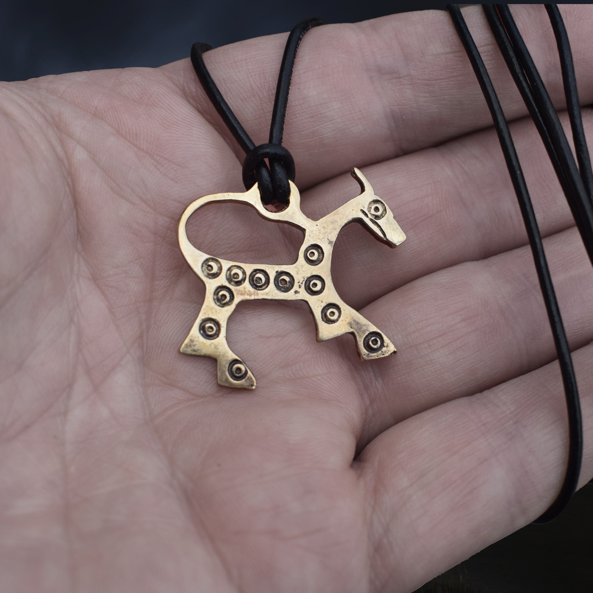 Bronze Replica Viking Horse Pendant from Novgorod on Leather Cord Wrapped Around Hand