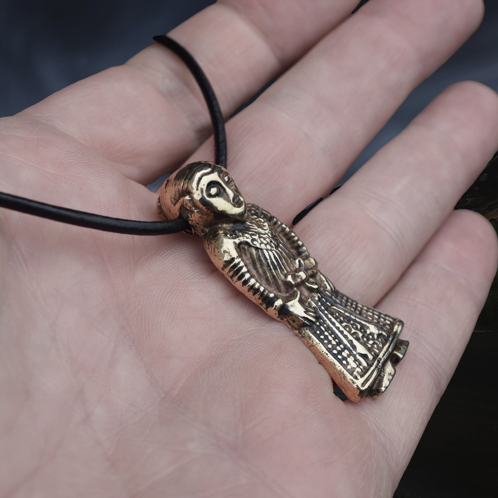 Large Bronze Viking Woman Pendant Replica from Revninge, Denmark on Leather Cord, on Hand - Side Angle View