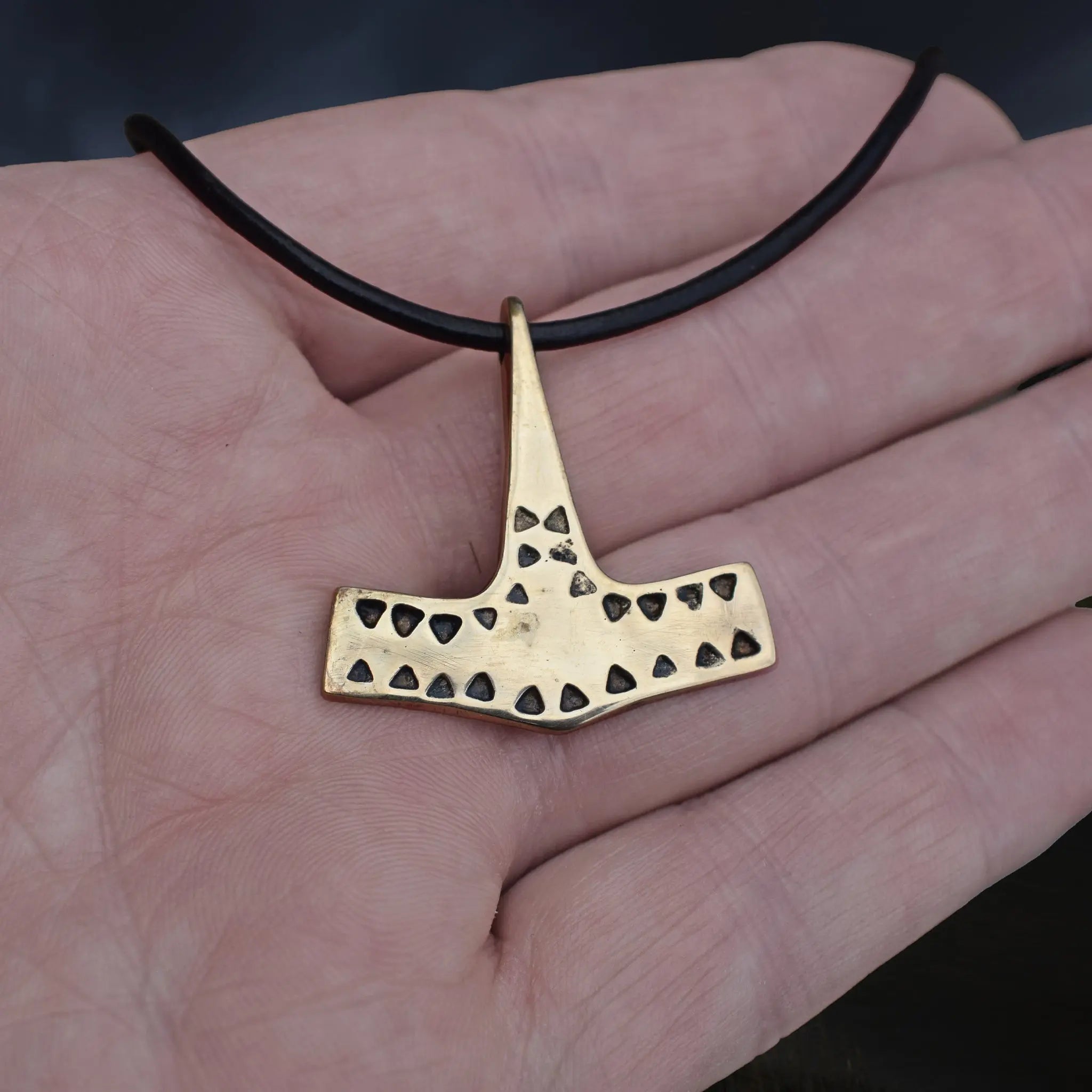 Bronze Viking Thor's Hammer Pendant Replica from 10th Century Denmark with Triangle Patterns on Leather Cord on Hand