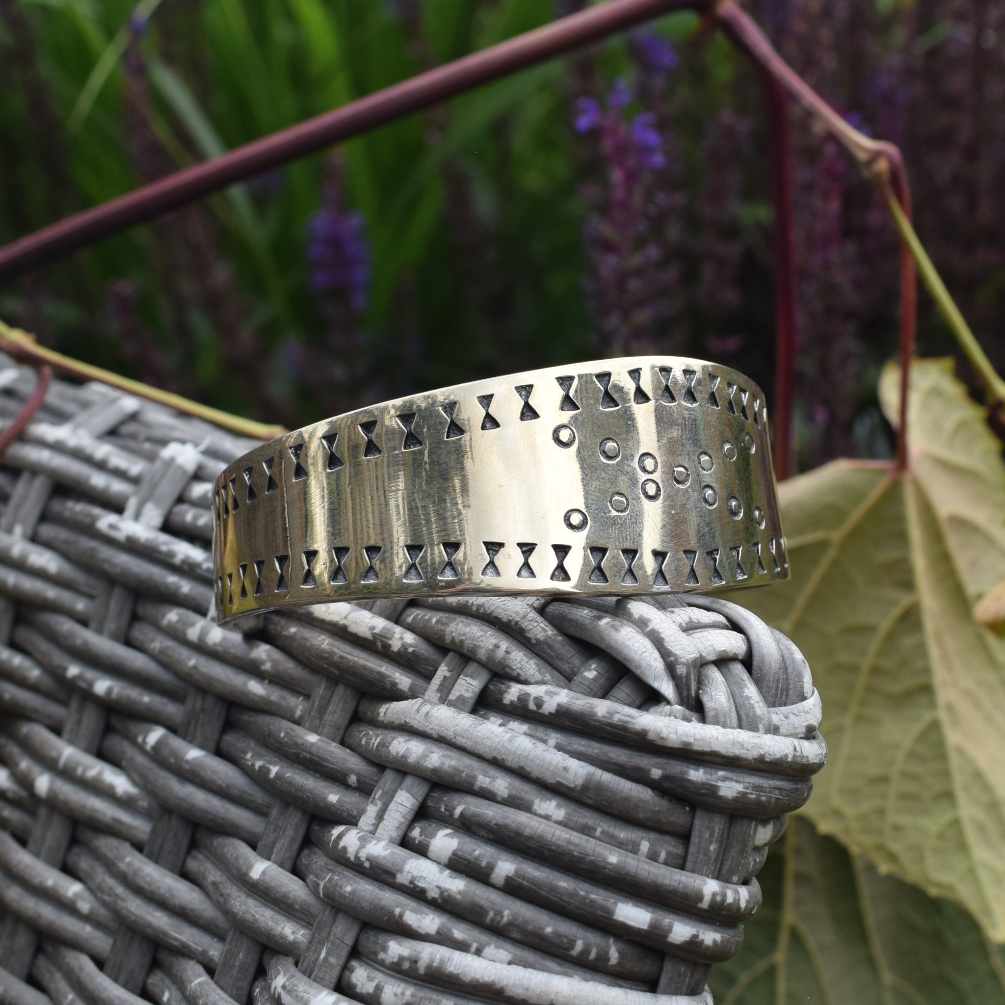 Bronze Viking Bracelet / Arm Ring Replica from Cuerdale on Chair Arm - Side View with Nature