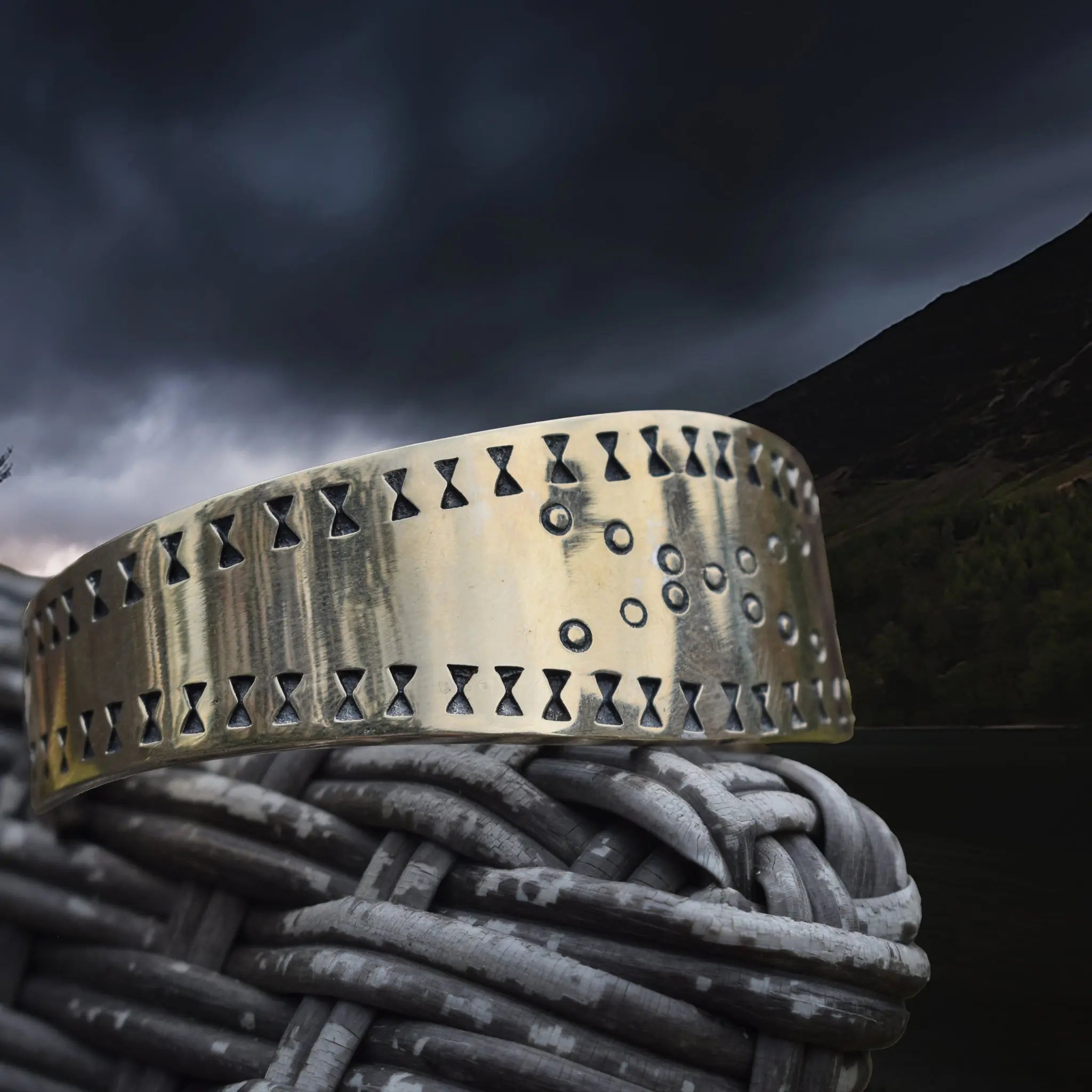 Bronze Viking Bracelet / Arm Ring Replica from Cuerdale on Chair Arm - Side Angle View