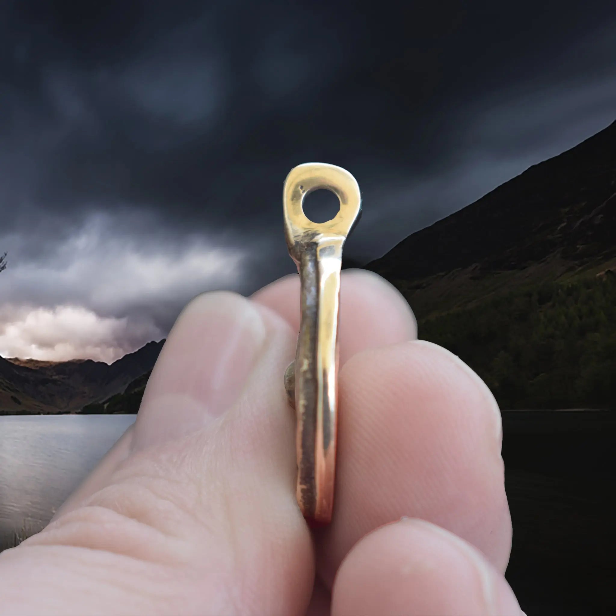 Bronze Round Replica Viking Luck / Good Health Pendant in Fingers - Side View