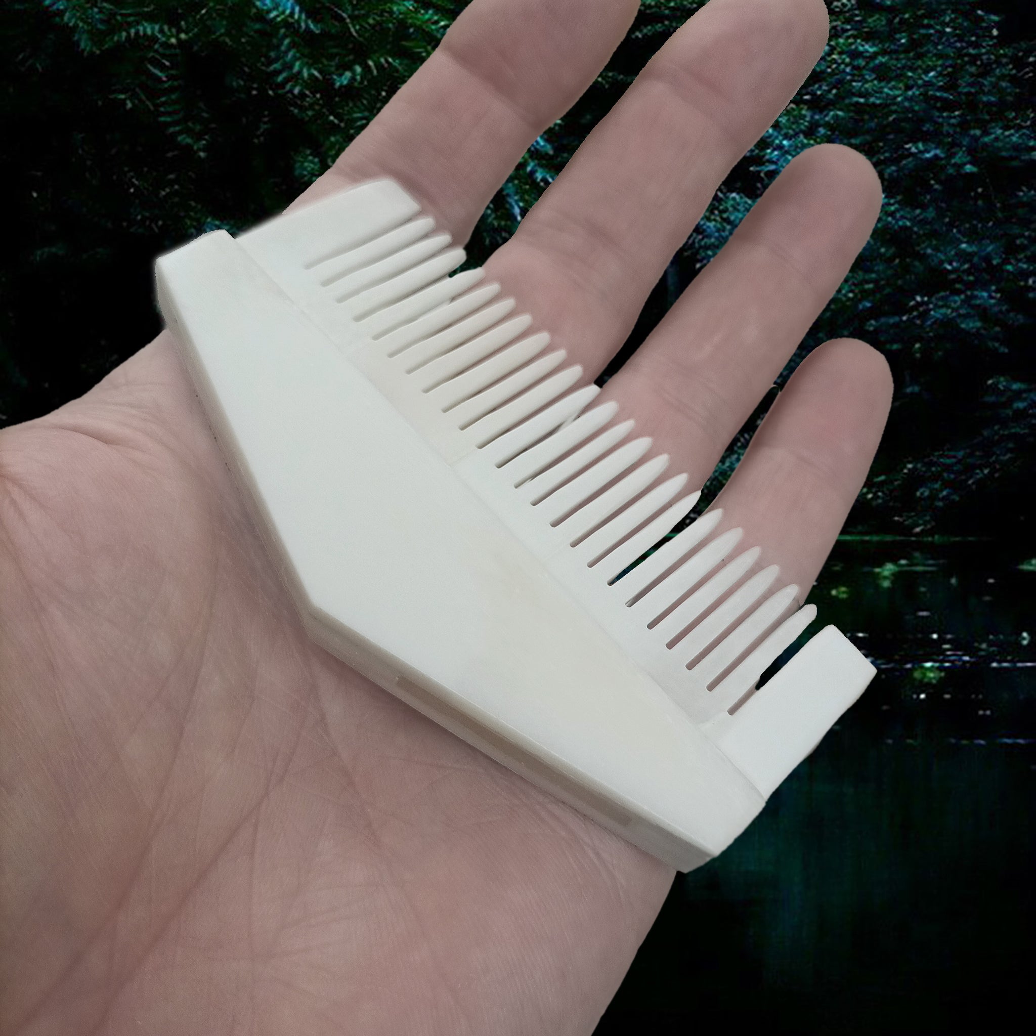 Authentic Handmade Replica Viking Bone Comb in a Triangular Shape on Hand - Angle View