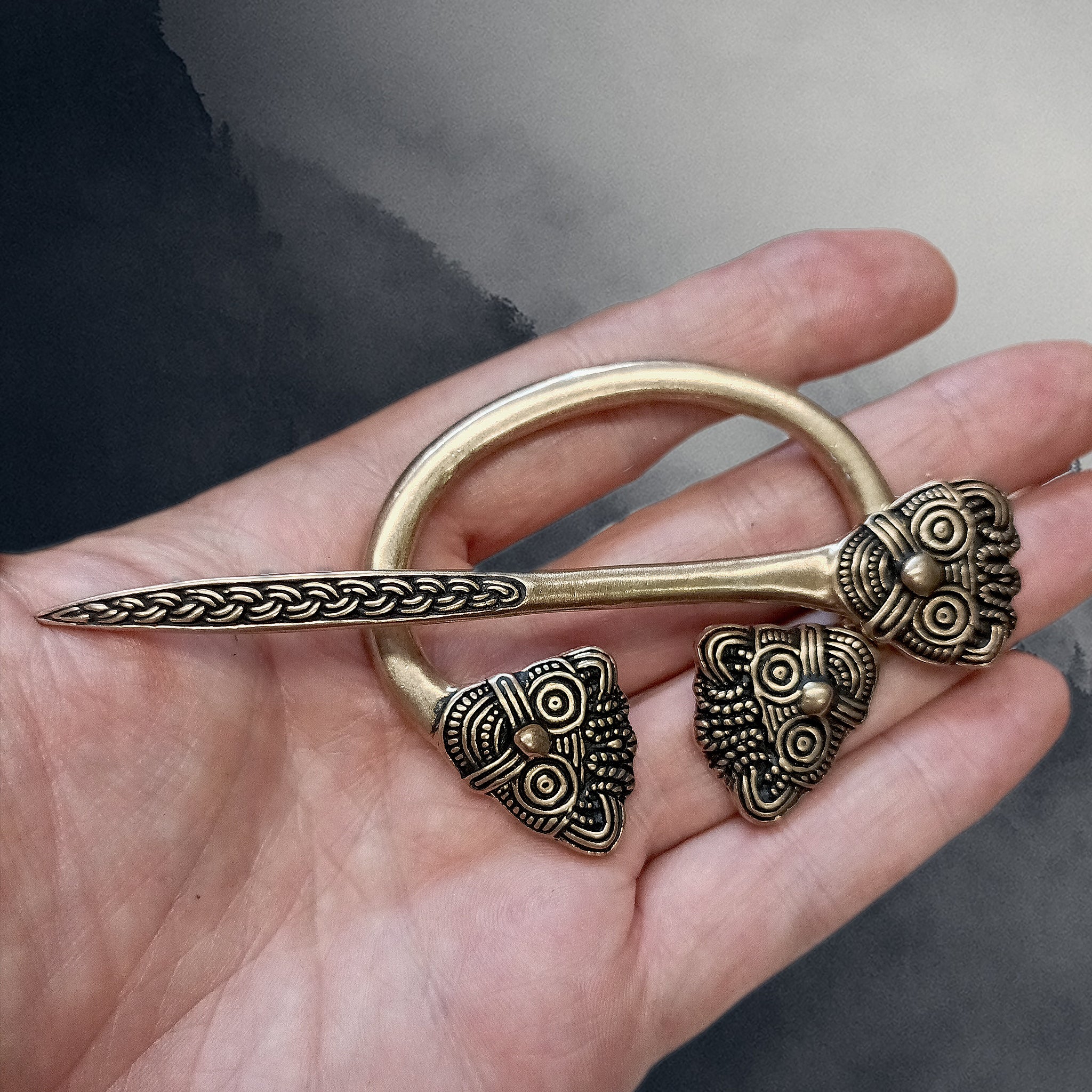 Bronze Danish Penannular Brooch with Viking Heads on Hand