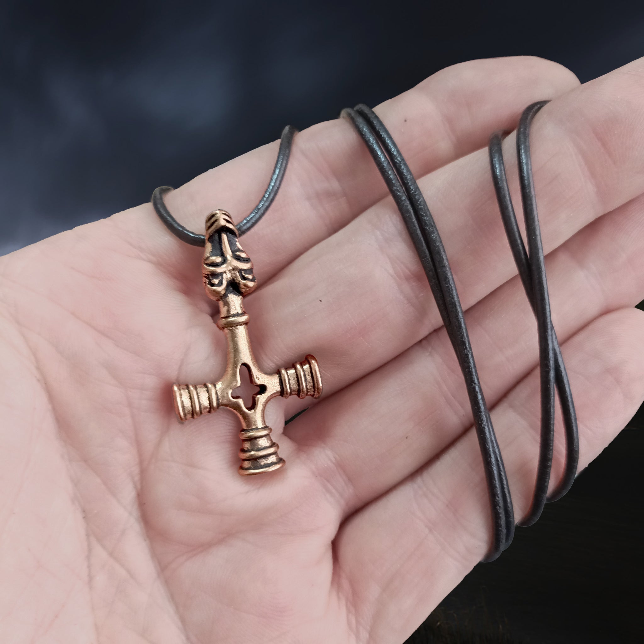 Bronze Wolf Cross Thors Hammer Pendant on Hand with Black Leather Cord