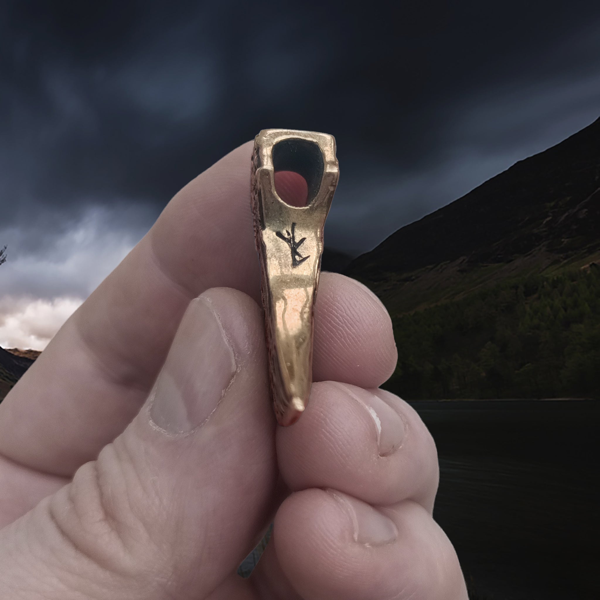 Bronze Knotwork Axe Head Pendant in Hand - Underside View
