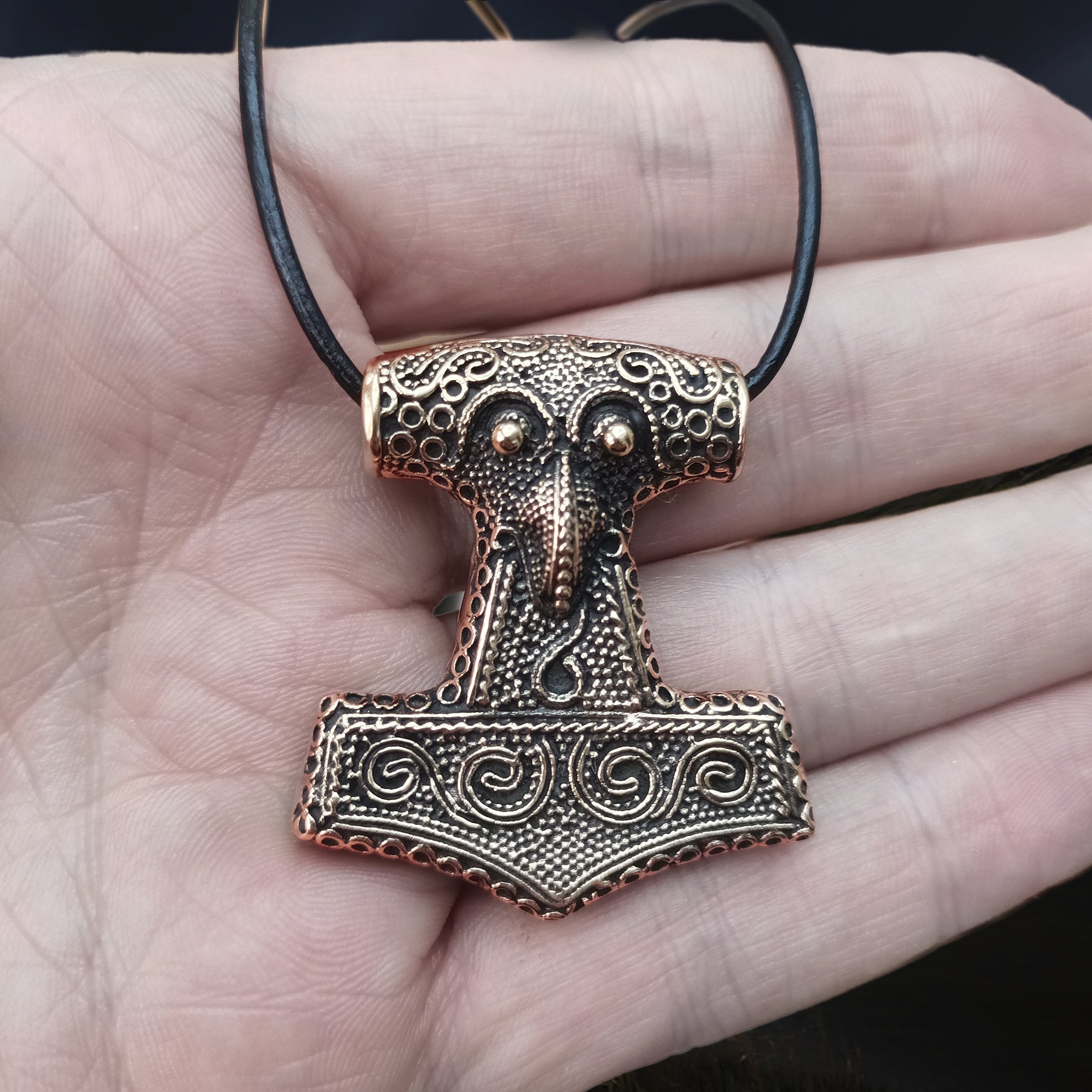 Large Bronze Skåne Thors Hammer Pendant on Thong on Hand