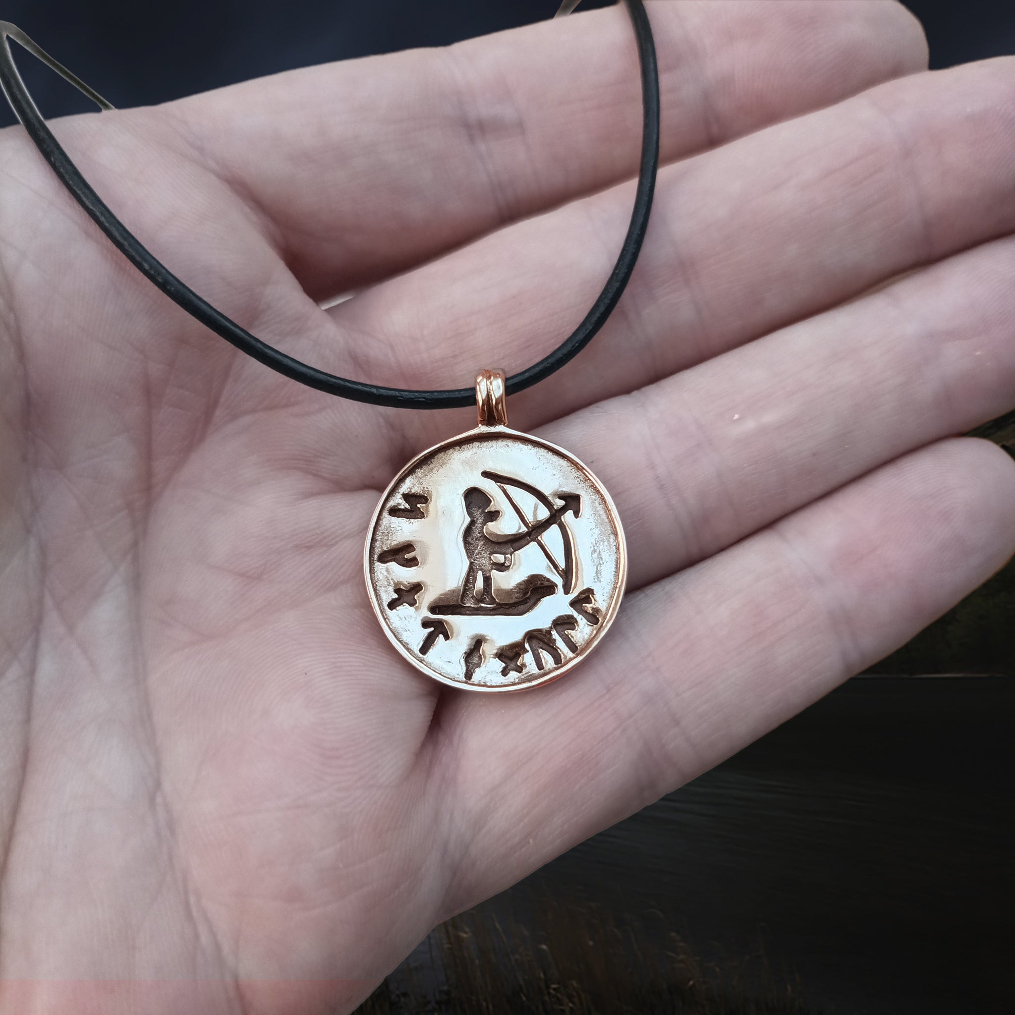Bronze Skadi Ull Viking Pendant on Leather Thong on Hand