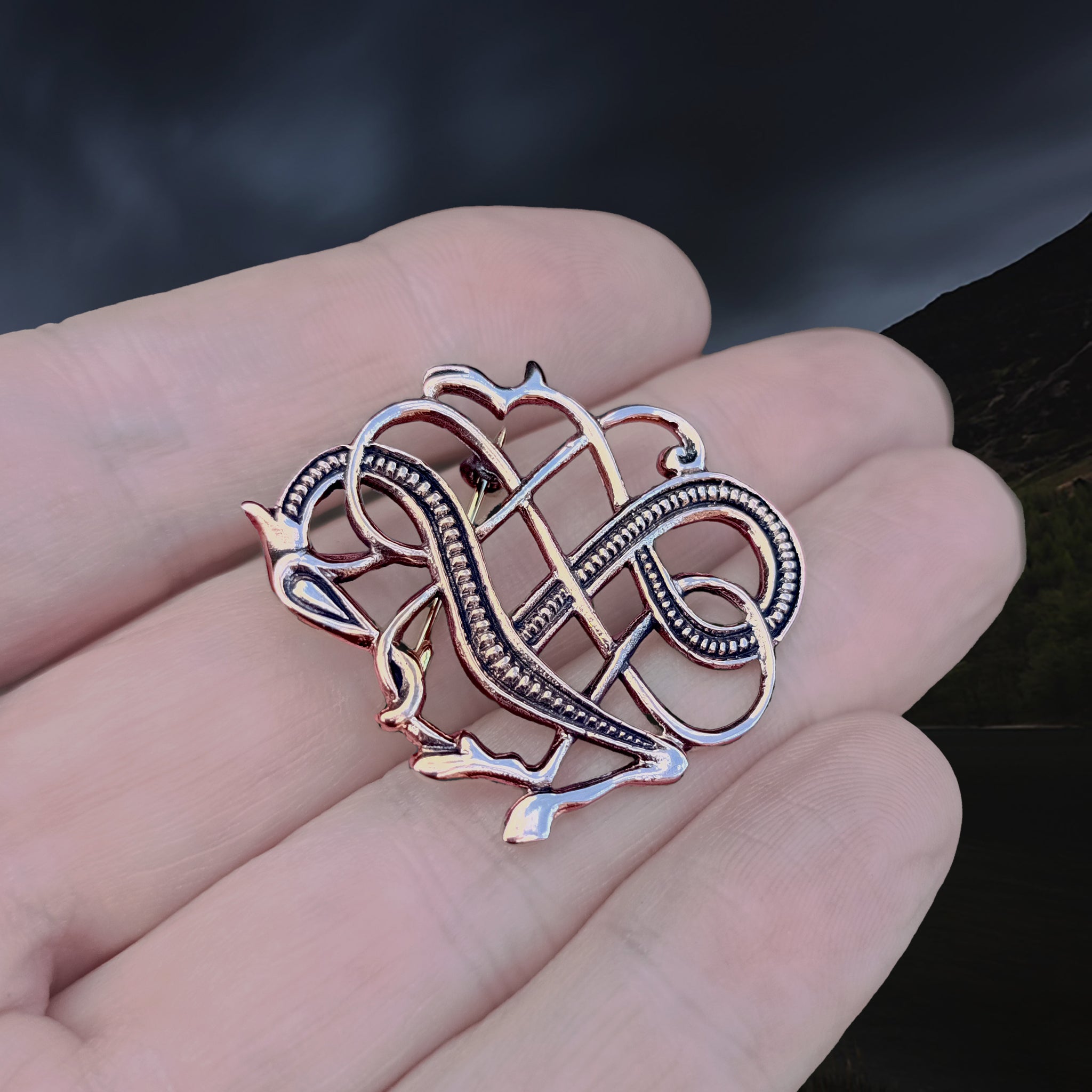 Bronze Urnes Dragon Viking Brooch Replica from 11th Century Iceland on Hand - Angle View