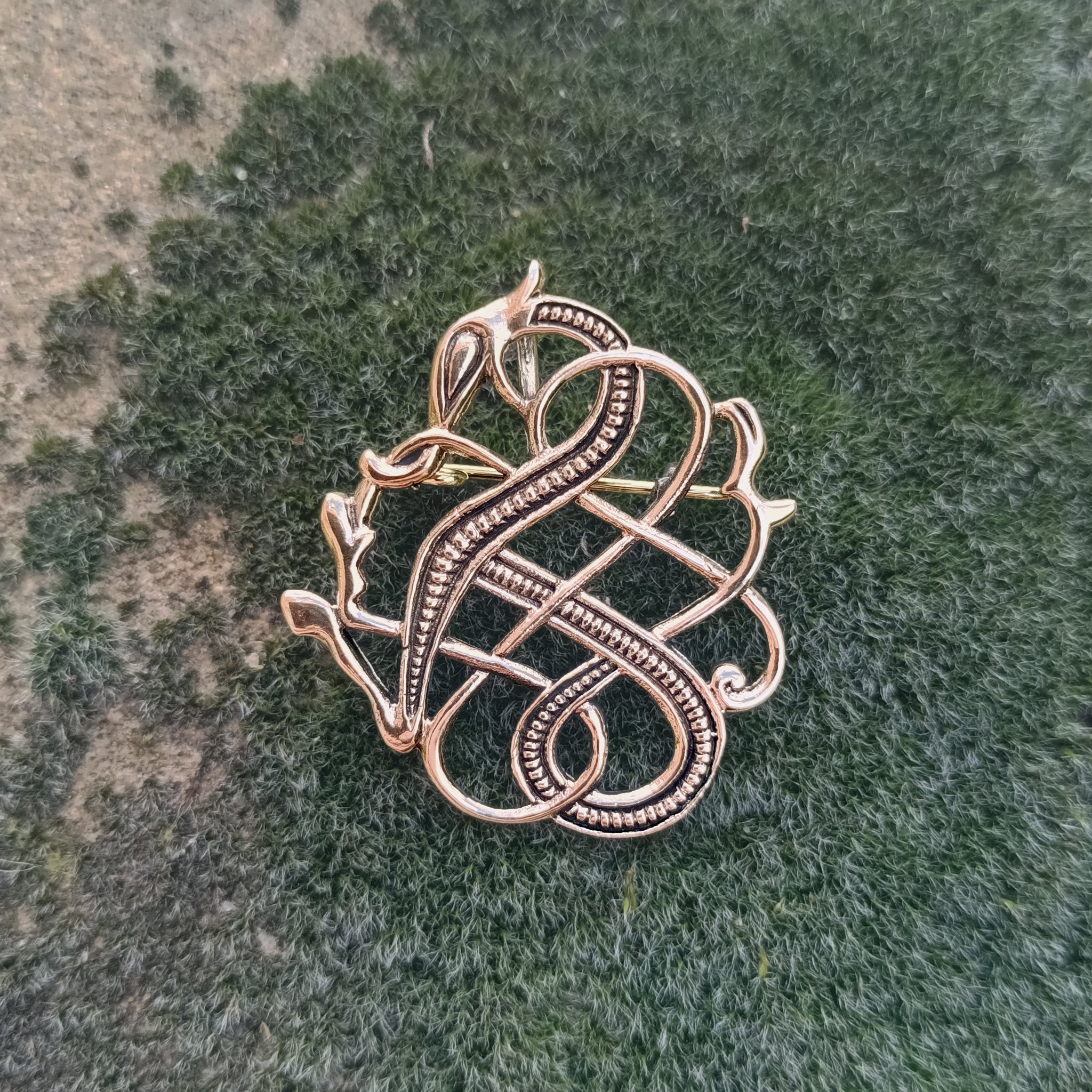 Bronze Urnes Dragon Viking Brooch Replica from 11th Century Iceland on Mossy Rock