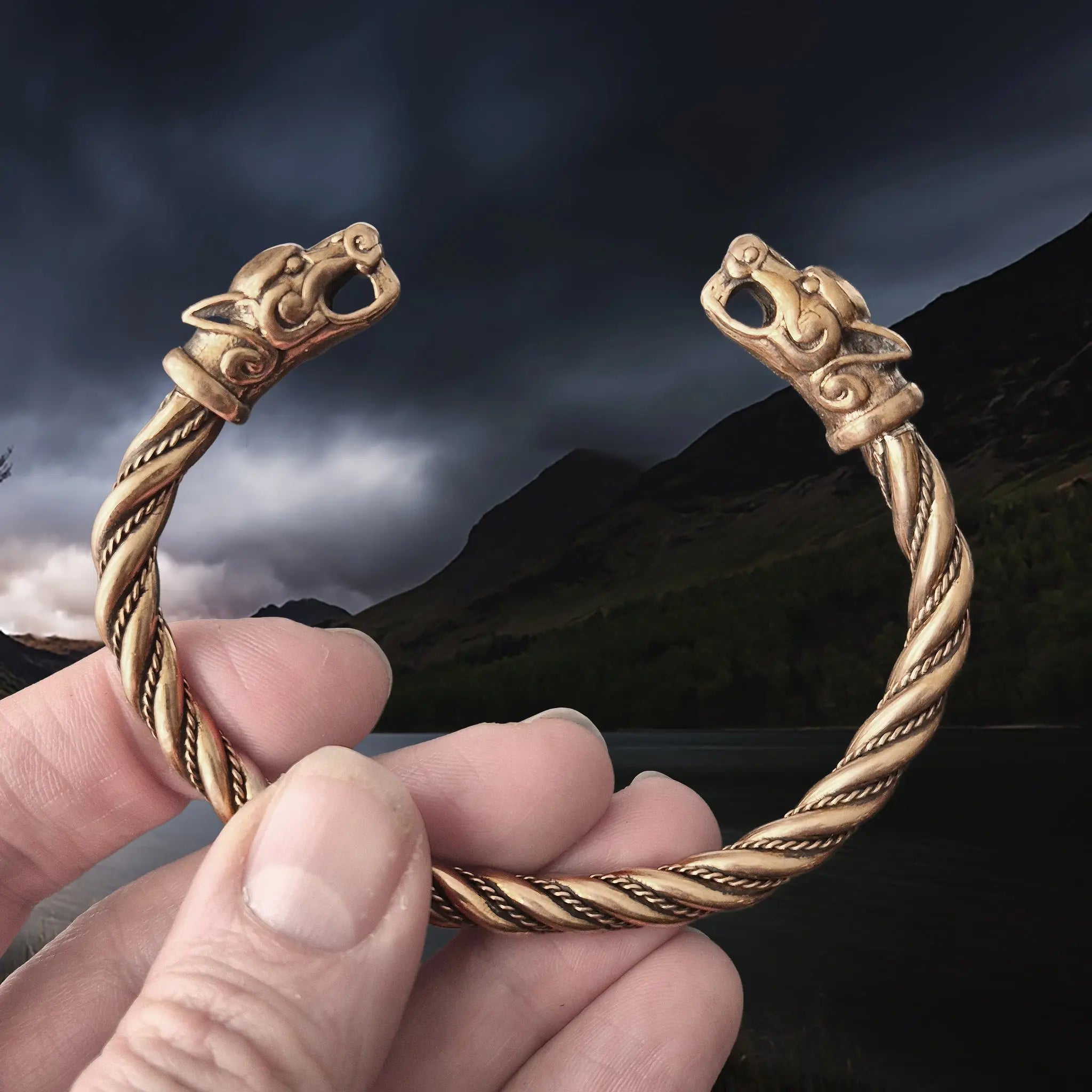 Handmade Twisted Viking Bronze Bracelet with Ferocious Wolf Heads in Hand