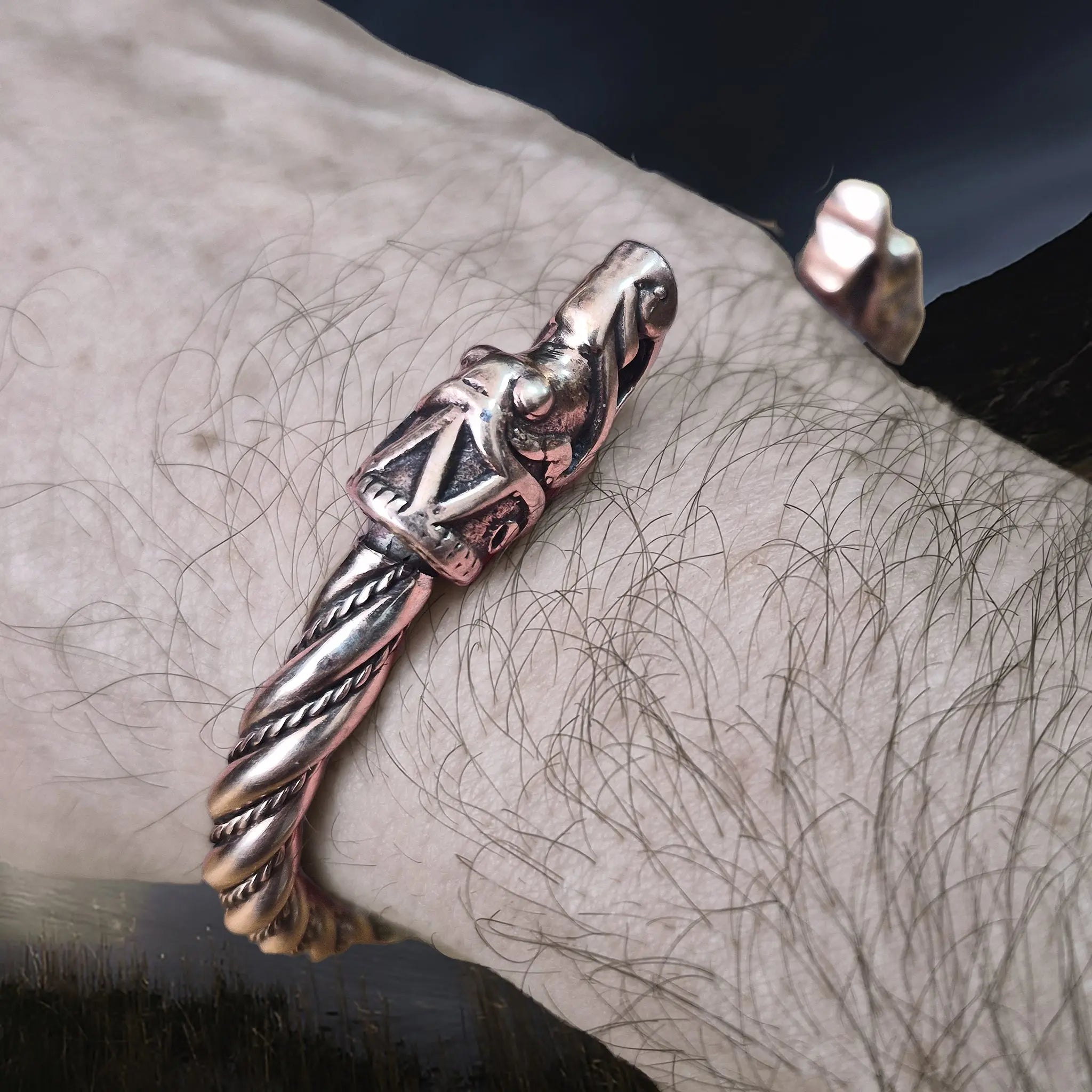 Handmade Twisted Bronze Bracelet With Gotlandic Dragon Heads on Wrist - Side Angle View