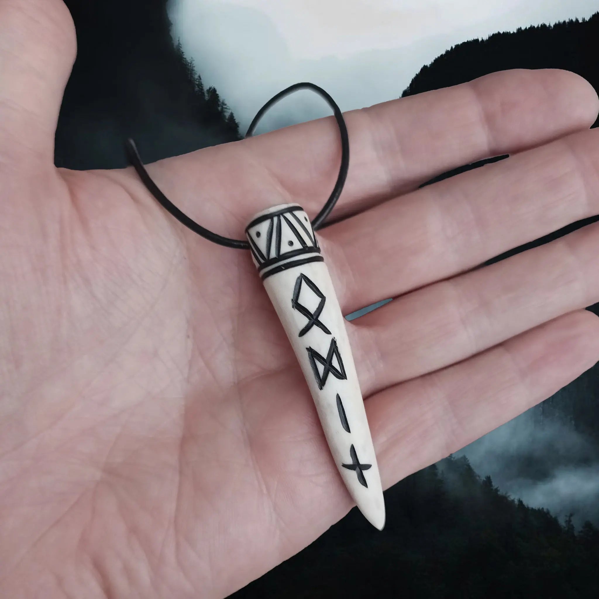 Carved Viking Pendant in Solid Antler with Odin Runes on Leather Cord - on Hand