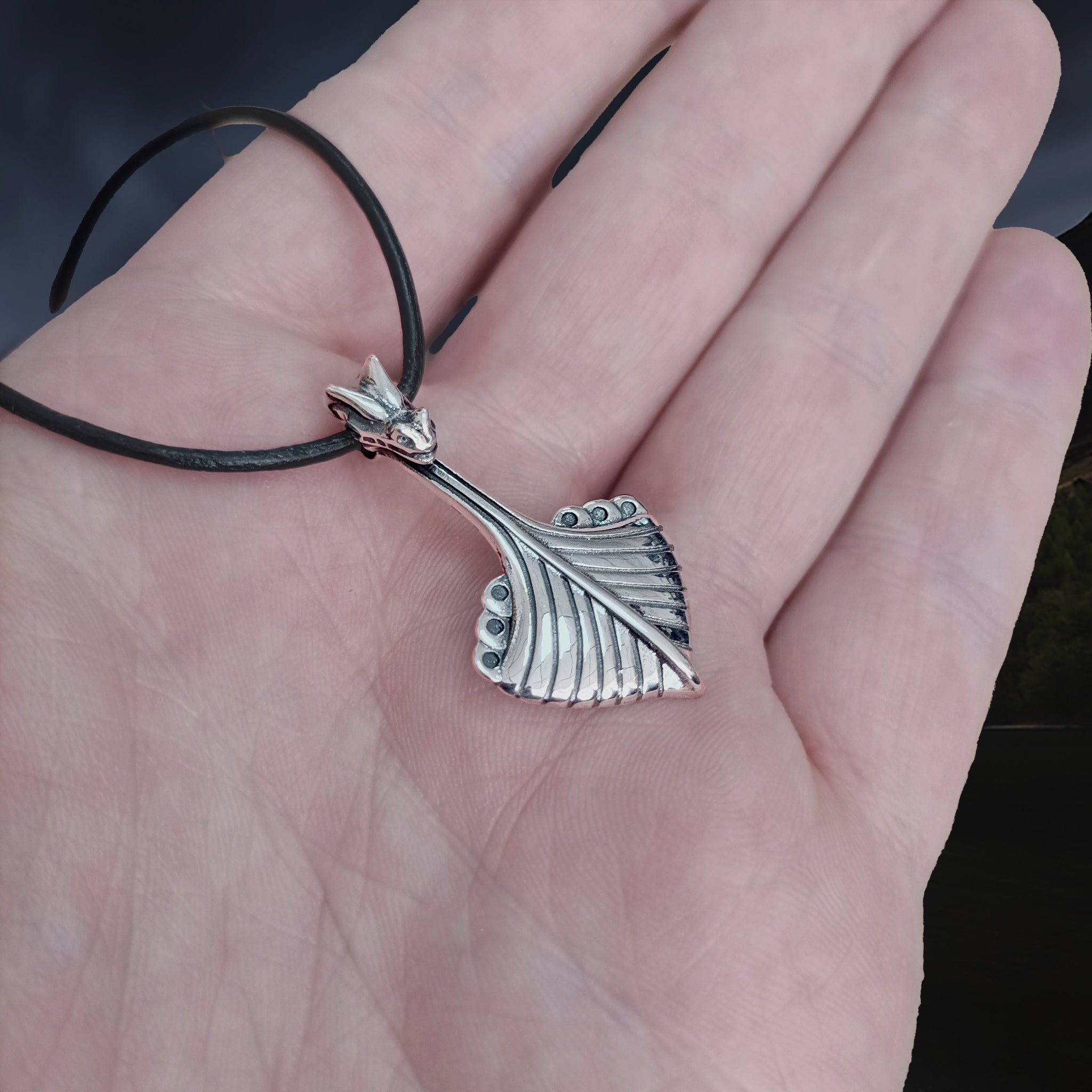 Replica Norwegian Viking Ship Pendant in Sterling Silver on Leather Cord on Hand - Side Angle View