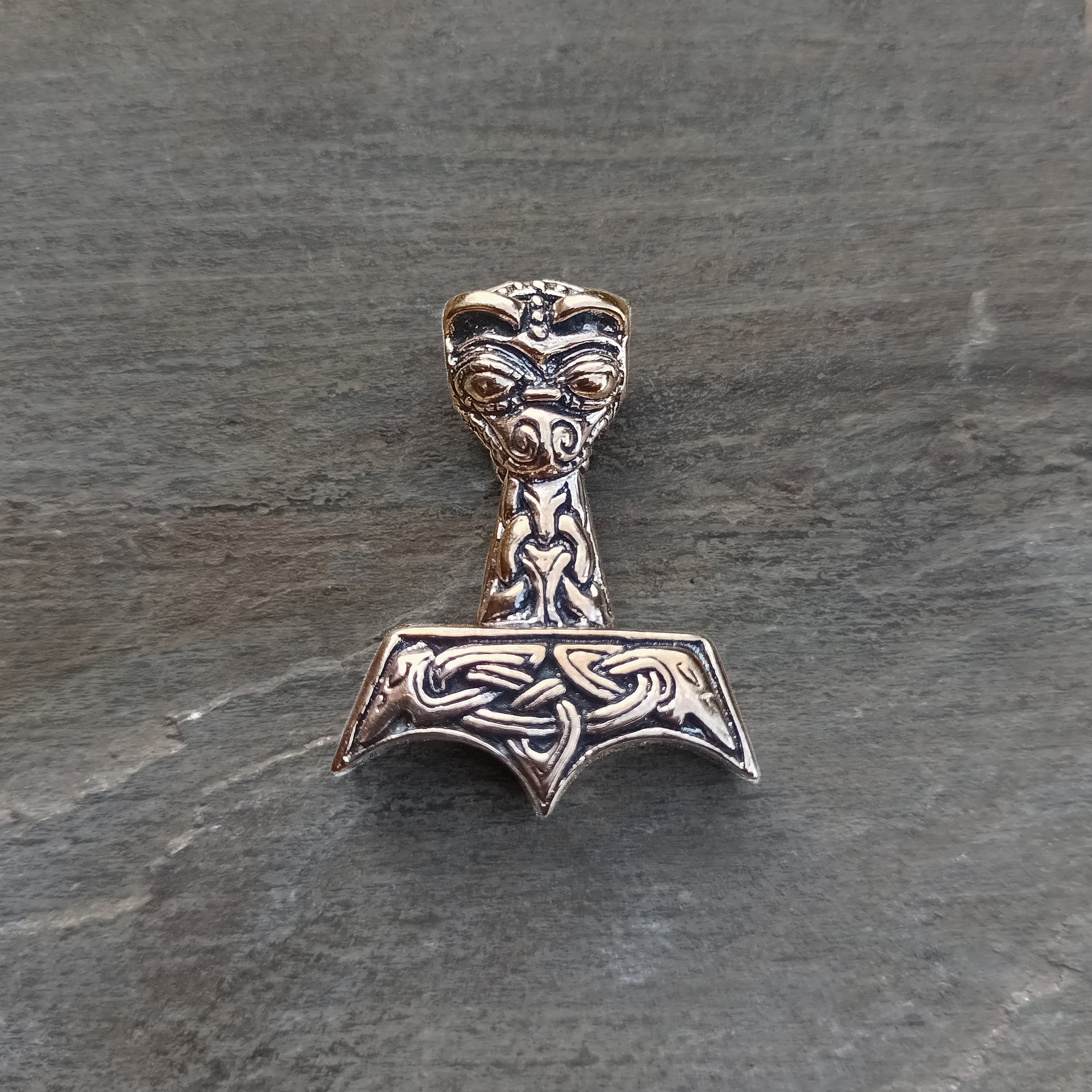 Bronze Ferocious Beast Thors Hammer Pendant on Rock