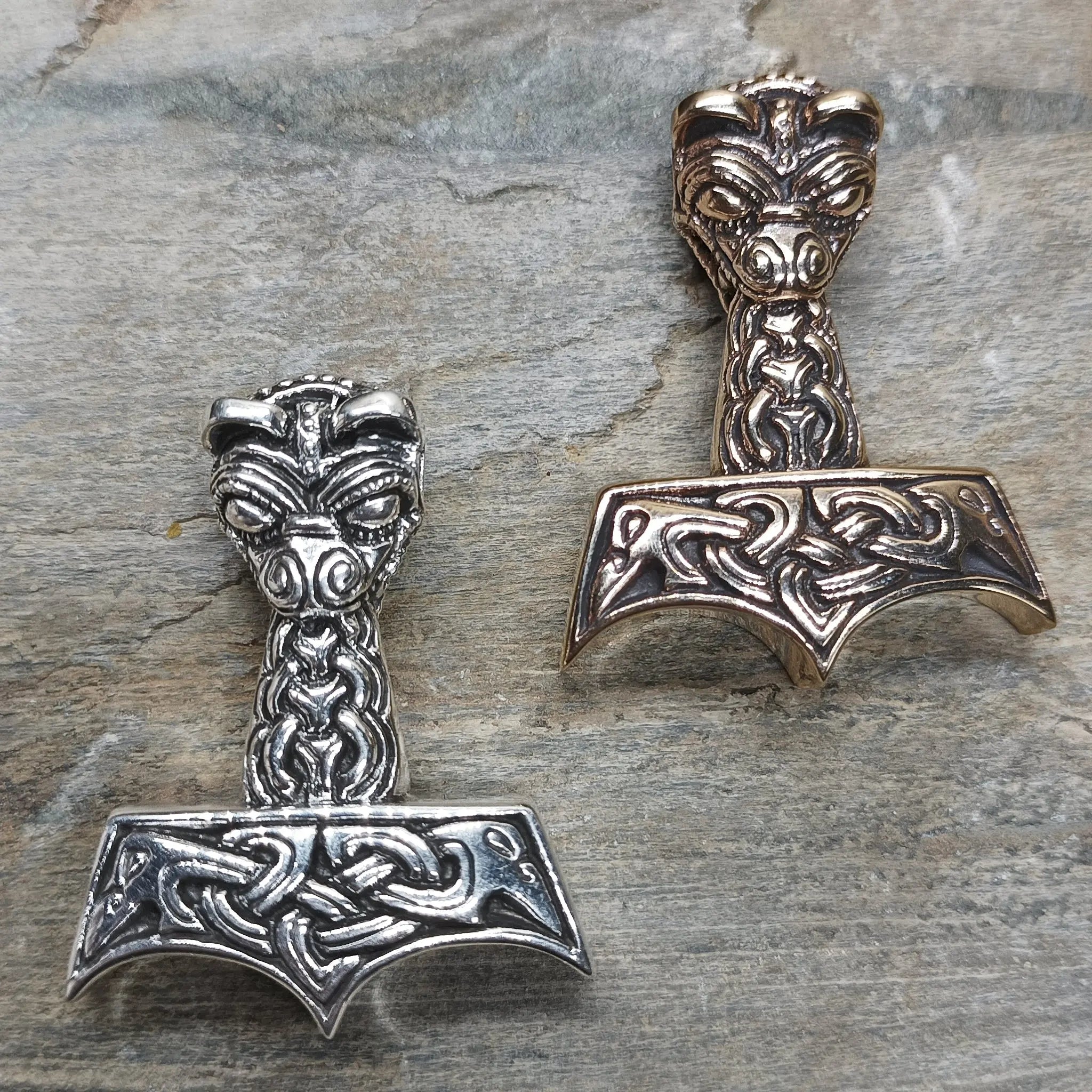 Large And Ferocious Thors Hammer Pendants on Rock - Silver and Bronze