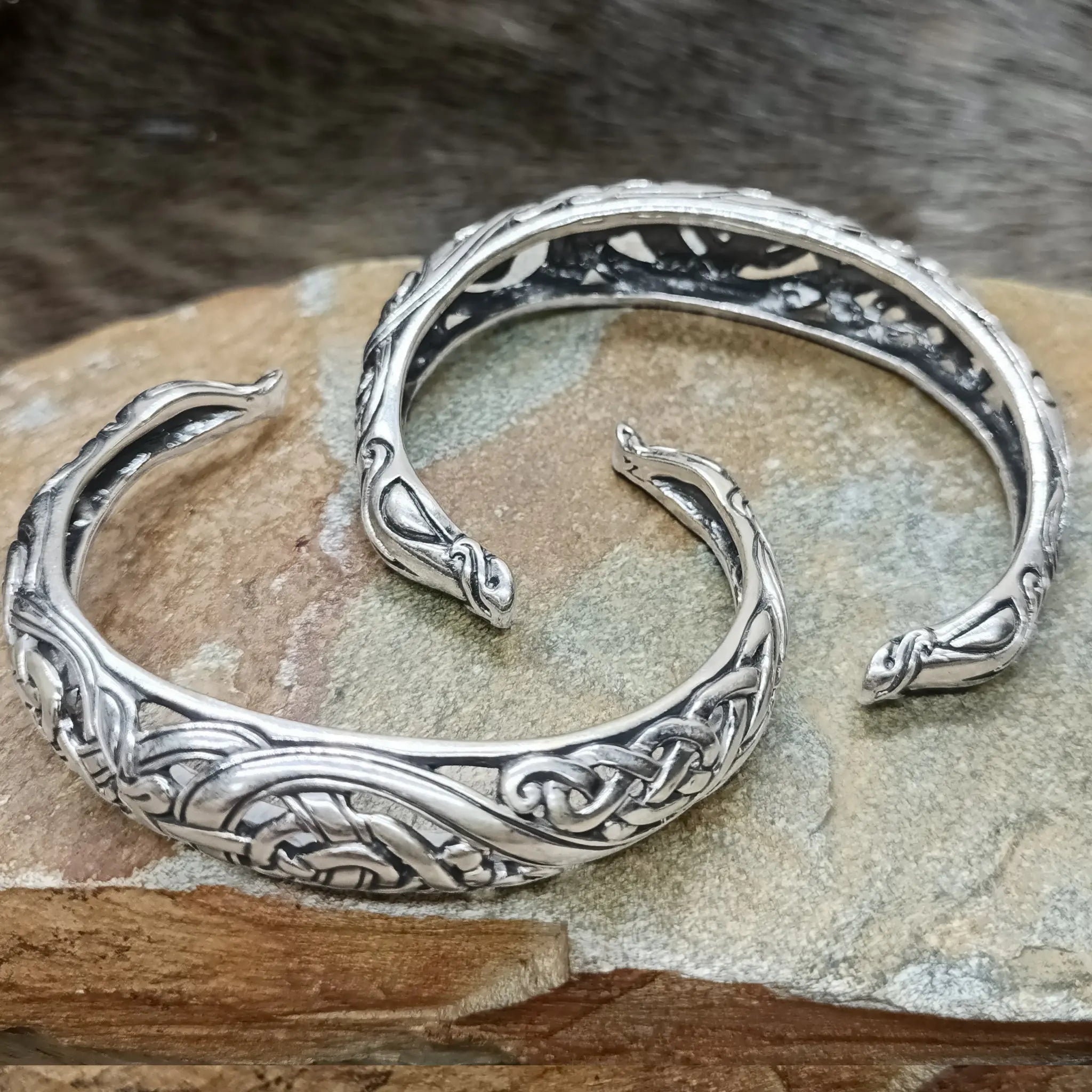 Silver Urnes Dragon Bracelets on Rock