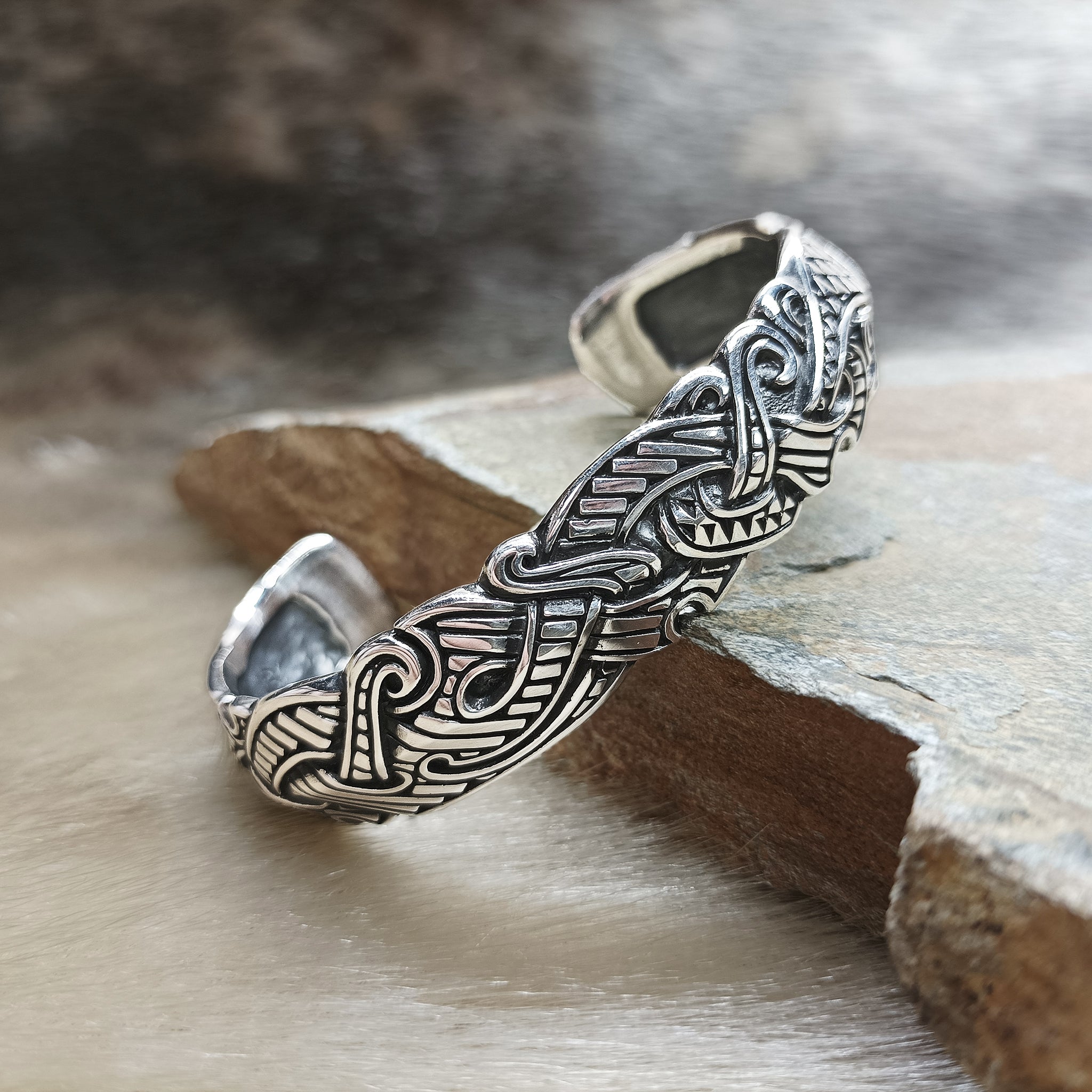 Silver Viking Raven Arm Ring on Rock - Angle View