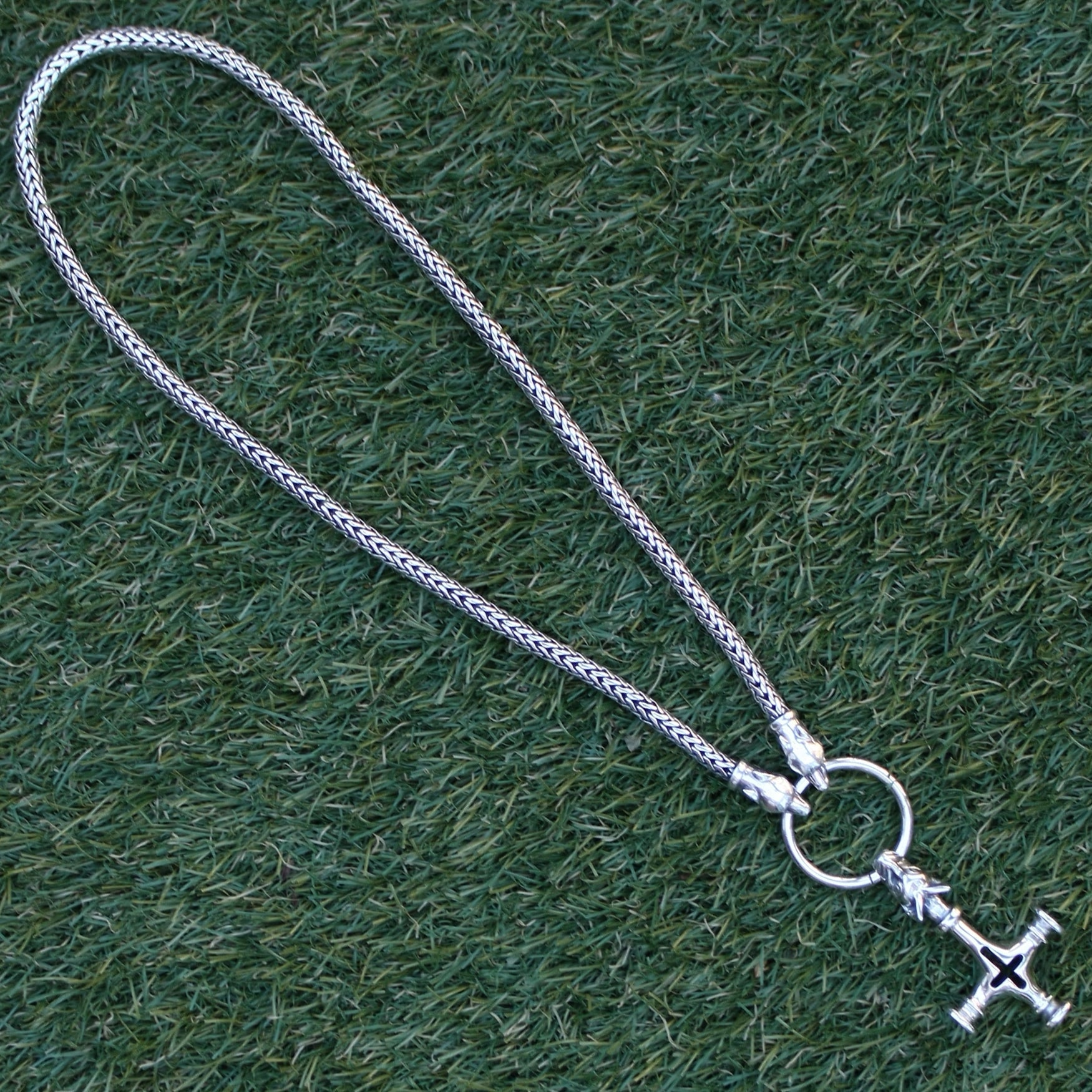Silver Thor's Hammer Necklace with Ferocious Wolf Heads and Large Icelandic Thor's Hammer onm Grass - Viking Jewelry