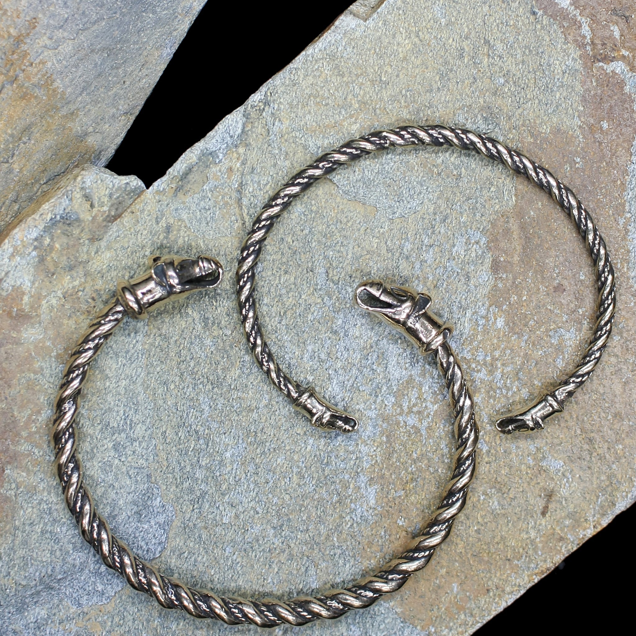 Twisted Bronze Bracelet With Icelandic Wolf Heads on Rock