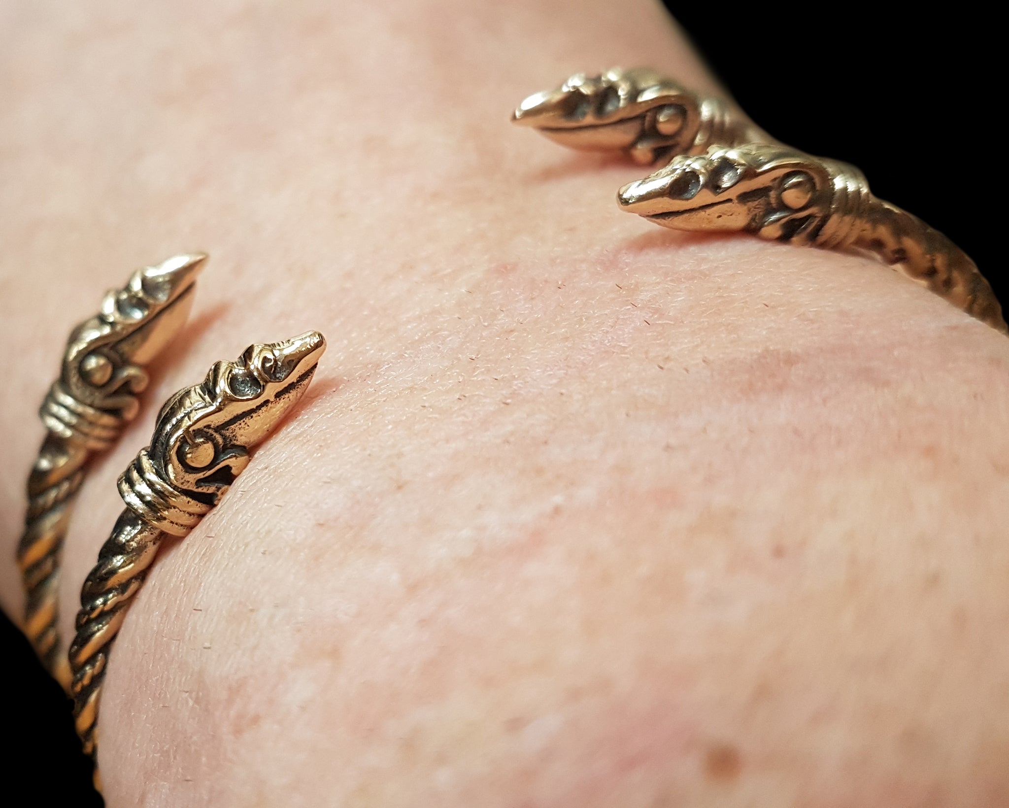 Twisted Bronze Bracelets With Raven Heads on Wrists Side View