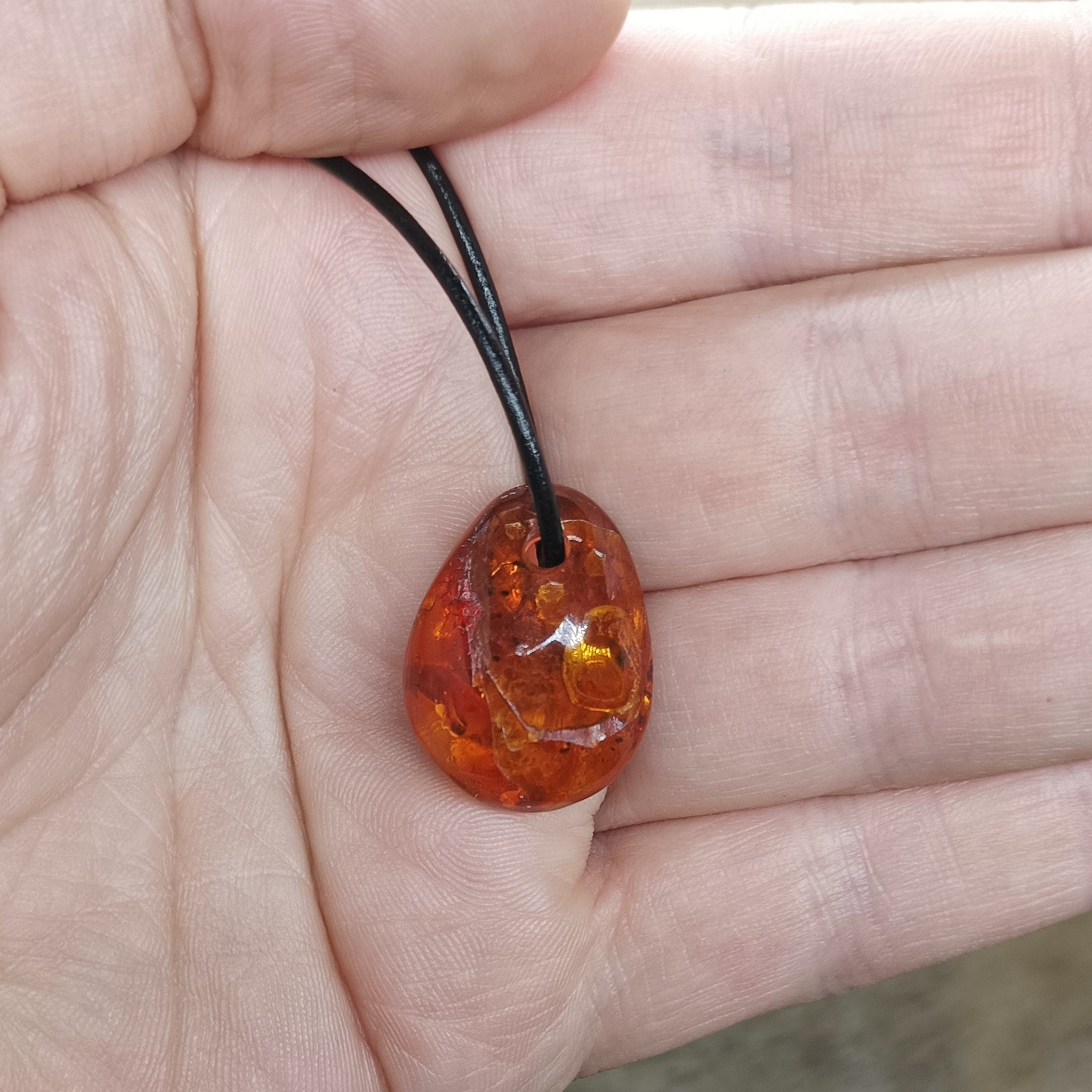 Amber Amulet Pendant on Hand with Leather Thong - Other Shape