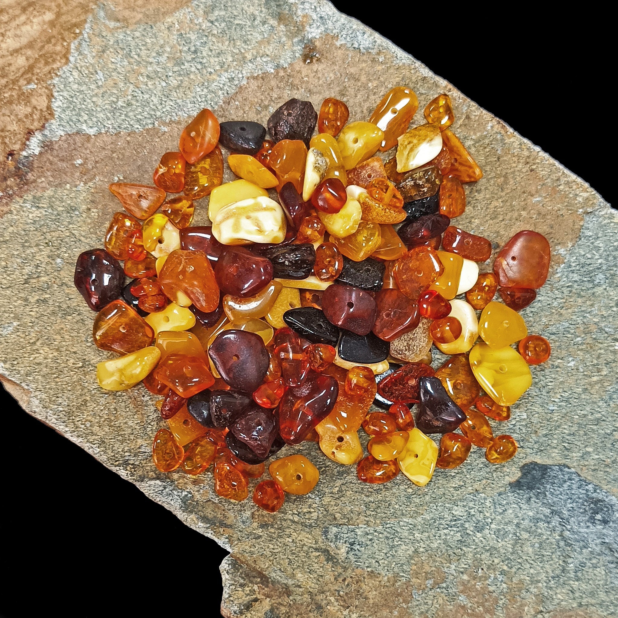 Polished Amber Chips With Drilled Holes on Rock x 20g