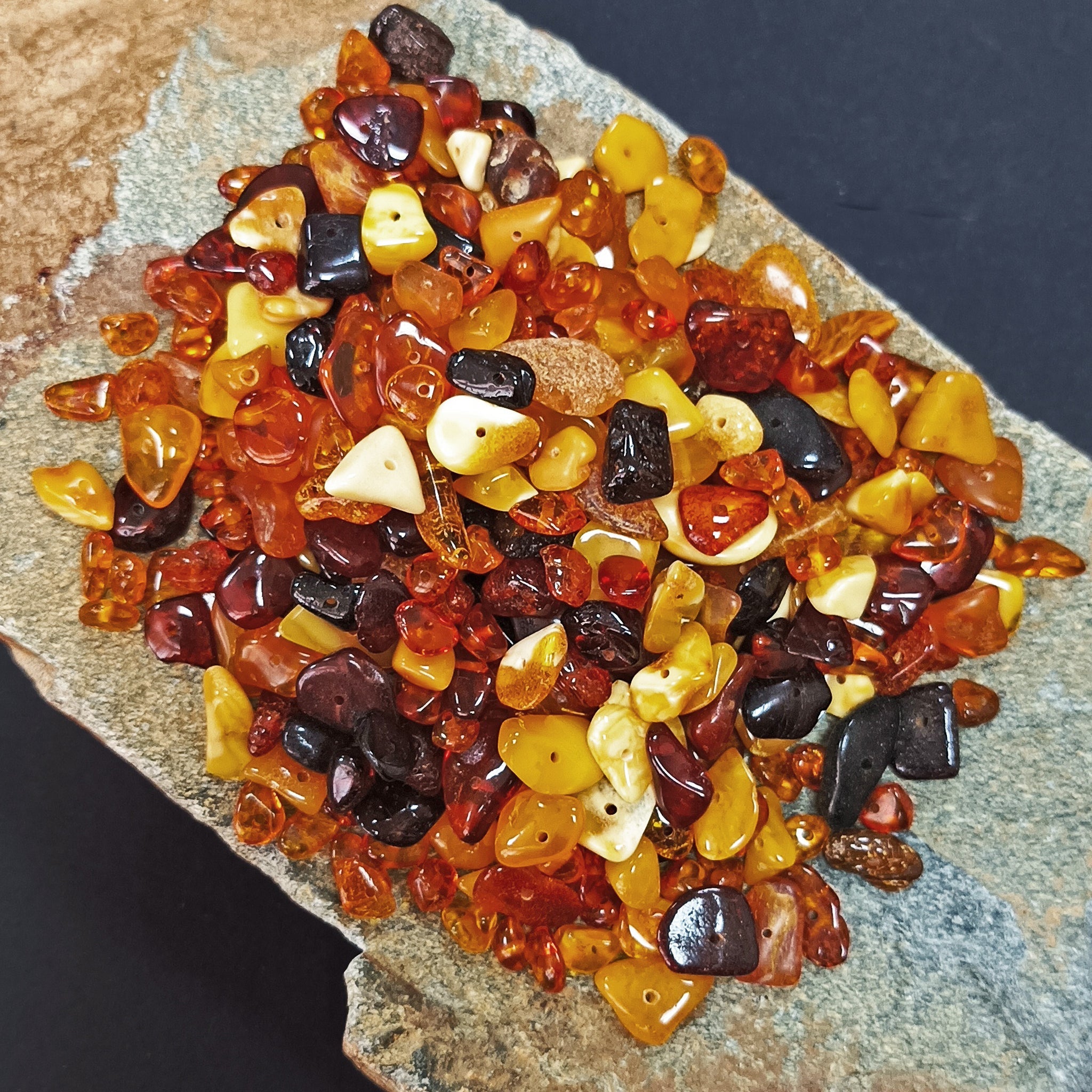 Polished Amber Chips With Drilled Holes on Rock x 50g