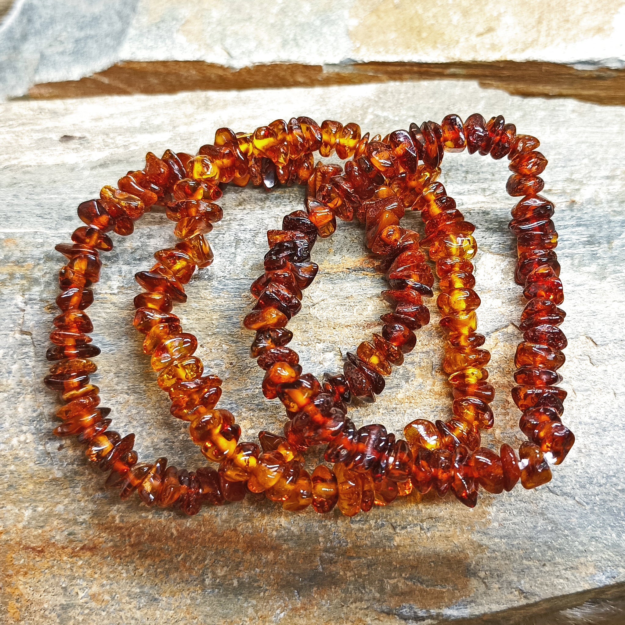 Polished Amber Chip Bracelets on Rock