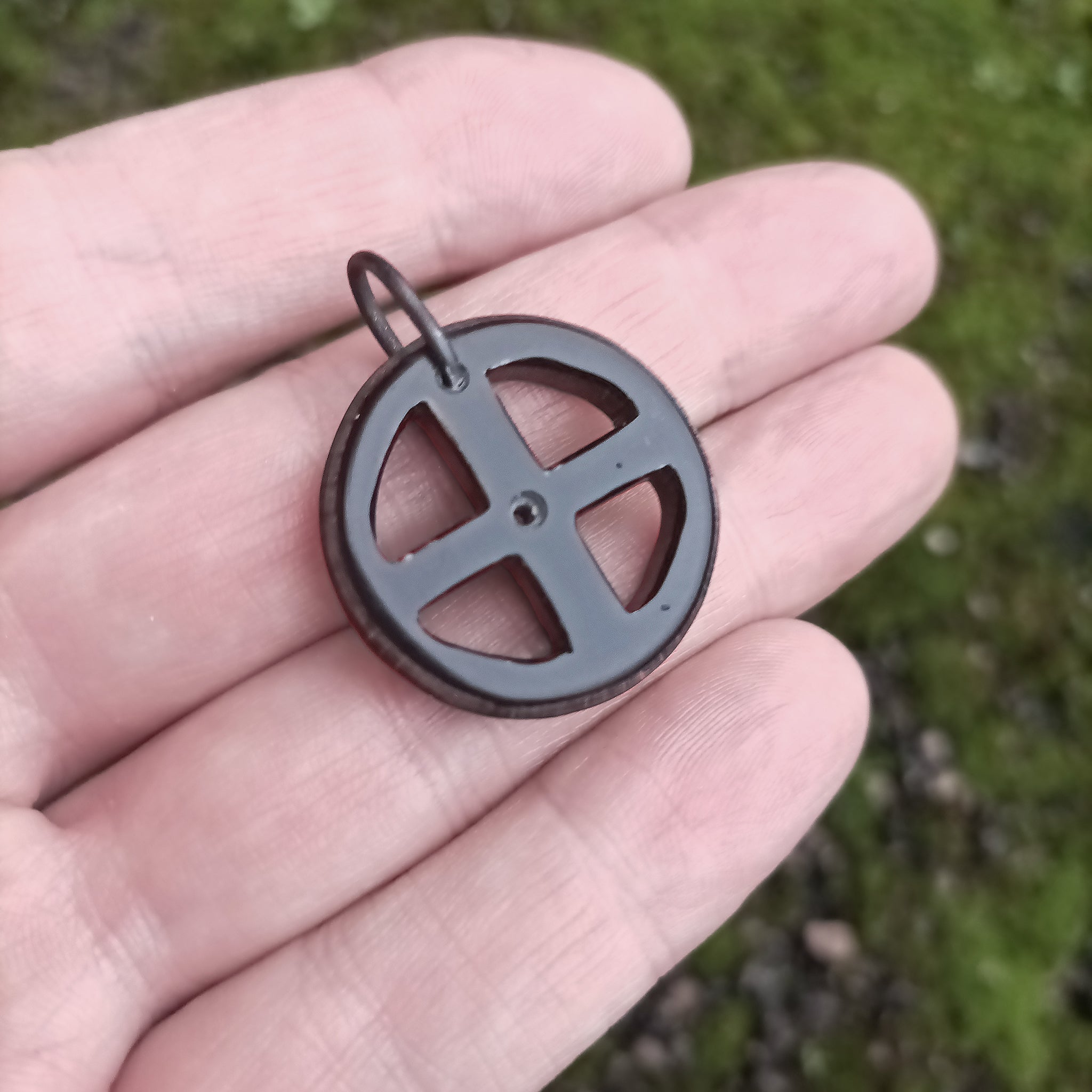 Black Horn Sun Cross Odin Pendant on Hand - Angle View